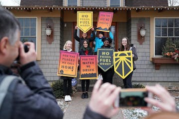 Students from iMatter, a youth-driven organization focused on climate change, posed with signs after recording a message at Rep.-elect Dean Phillips' 