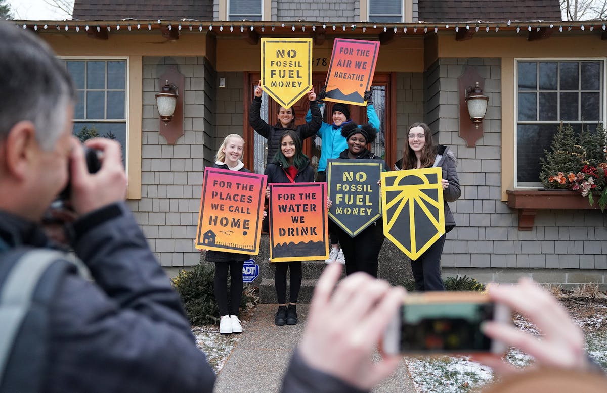 Students from iMatter, a youth-driven organization focused on climate change, posed with signs after recording a message at Rep.-elect Dean Phillips' 