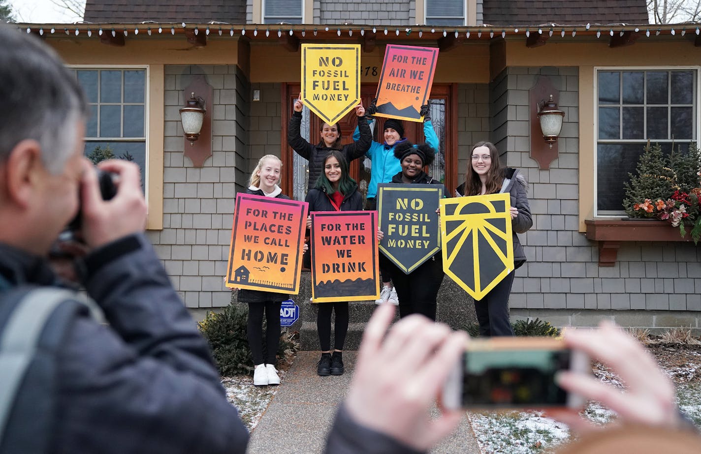 Students from iMatter, a youth-driven organization focused on climate change, posed with signs after recording a message at Rep.-elect Dean Phillips' Excelsior office.