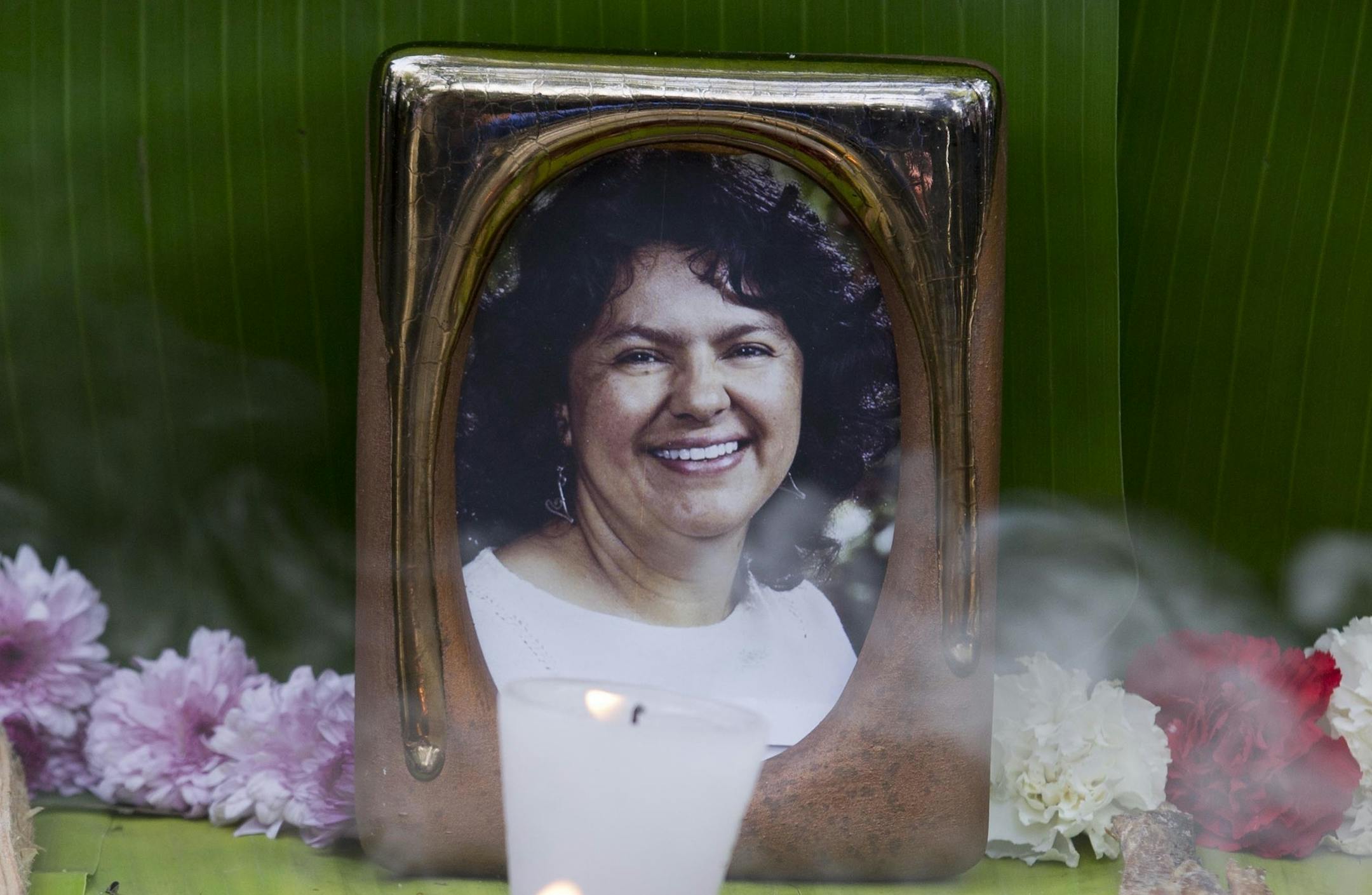 FILE - This June 15, 2016, file photo shows a framed image of environmentalist Berta Caceres on a makeshift altar made in her honor during a demonstration outside Honduras' embassy, in Mexico City. At least 200 land and environmental defenders were slain protecting forests, rivers and lands from mining, logging and agricultural companies in 2016 in the world’s deadliest recorded year for such activists, a watchdog group said Thursday, July 13, 2017. That included the high-profile murder o