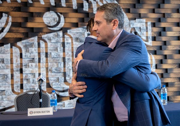 Twins General Manager Thad Levine hugged Byron Buxton after Buxton signed a contract extension before the 2022 season.