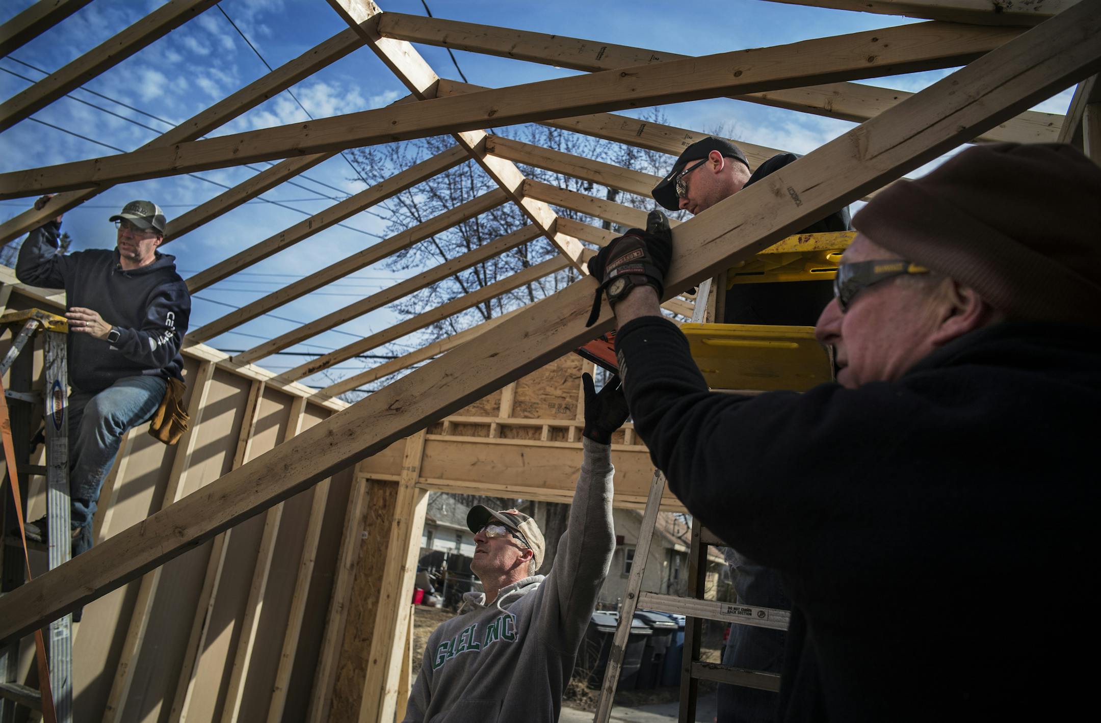 L to R: Joel Johnson, Bill Manning, Adam Vierthaler, and Eric Weatherman helped rebuild Tawanda Miller’s garage by working on the framing and sheeting.
