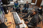 Mickey Breeze, center, worked with students Will Riordan 11, left , Nora Thul, 11, and Alexander Williamson, 12, to create music in a class at Powderh