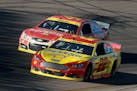 Driver Joey Logano (22) battled Kevin Harvick in turn one during the Quicken Loans Race for Heroes 500 at Phoenix International Raceway on Sunday.