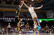 Totino-Grace’s Isaiah Johnson-Arigu (right) blocks the shot of DeLaSalle’s Jaden Morgan in the first half of the Class 3A semifinals Thursday at W