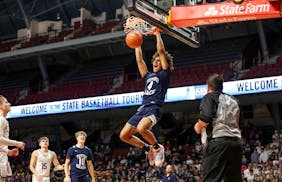 Isaiah Johnson dunked after an alley-oop pass from Totino-Grace teammate Chace Watley in the first half. 