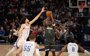 Wolves guard Anthony Edwards attempts to shoot over the outstretched arm of Thunder forward Chet Holmgren on Feb. 23 at Target Center.