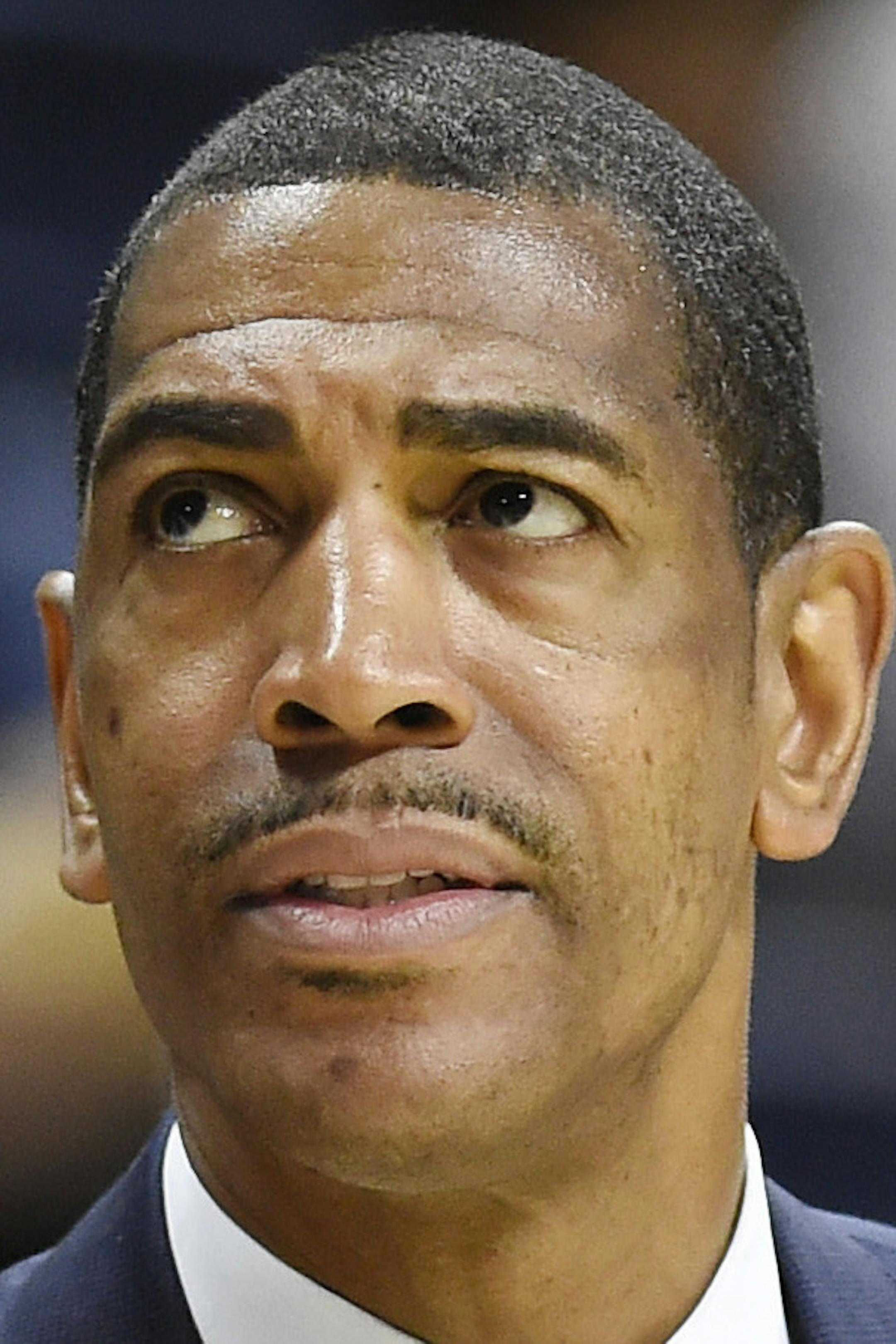 FILE - In this Dec. 9, 2017 file photo, Connecticut head coach Kevin Ollie looks up at the scoreboard during the first half of an NCAA college basketball game against Coppin State in Storrs, Conn. UConn has fired Ollie, with the team under NCAA investigation and the Huskies having completed their second straight losing season. The university said in a statement Saturday, March 10, 2018, it has "initiated disciplinary procedures" to dismiss him for "just cause." The school says it would have no f