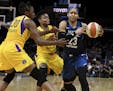 Minnesota Lynx forward Maya Moore (23) controls the ball against Los Angeles Sparks' Nneka Ogwumike (30) and Alana Beard in the second half of a singl