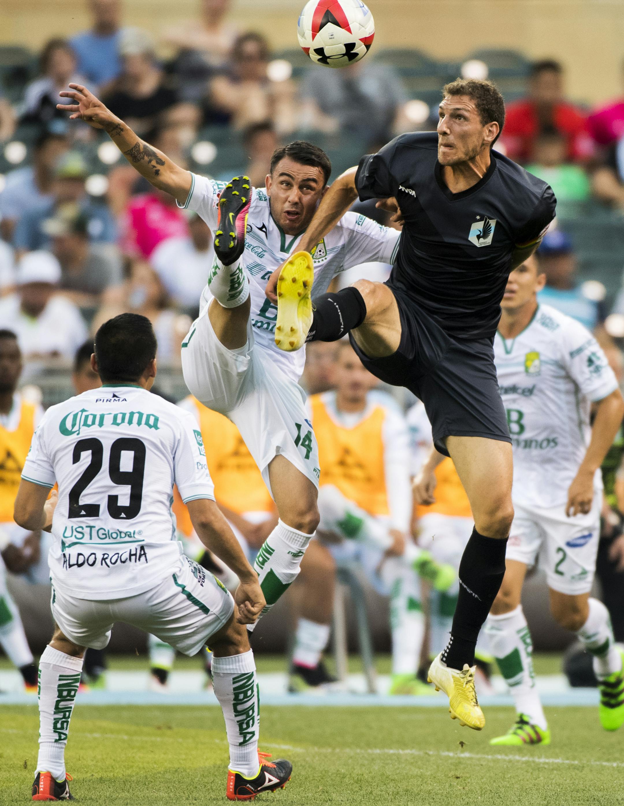 Minnesota United FC midfielder Aaron Pitchkolan (4) and Leon midfielder Miguel Ibarra (14) both went for an aerial kick in the first half. ] Isaac Hale • isaac.hale@startribune.com Minnesota United FC took on Club Leon at Target Field in Minnesota, MN, on Sunday June 25, 2016.