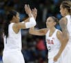 United States' Diana Taurasi, center, celebrates with teammates Maya Moore, left, and Brittney Griner, right, during a quarterfinal round basketball g