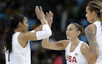 United States' Diana Taurasi, center, celebrates with teammates Maya Moore, left, and Brittney Griner, right, during a quarterfinal round basketball g
