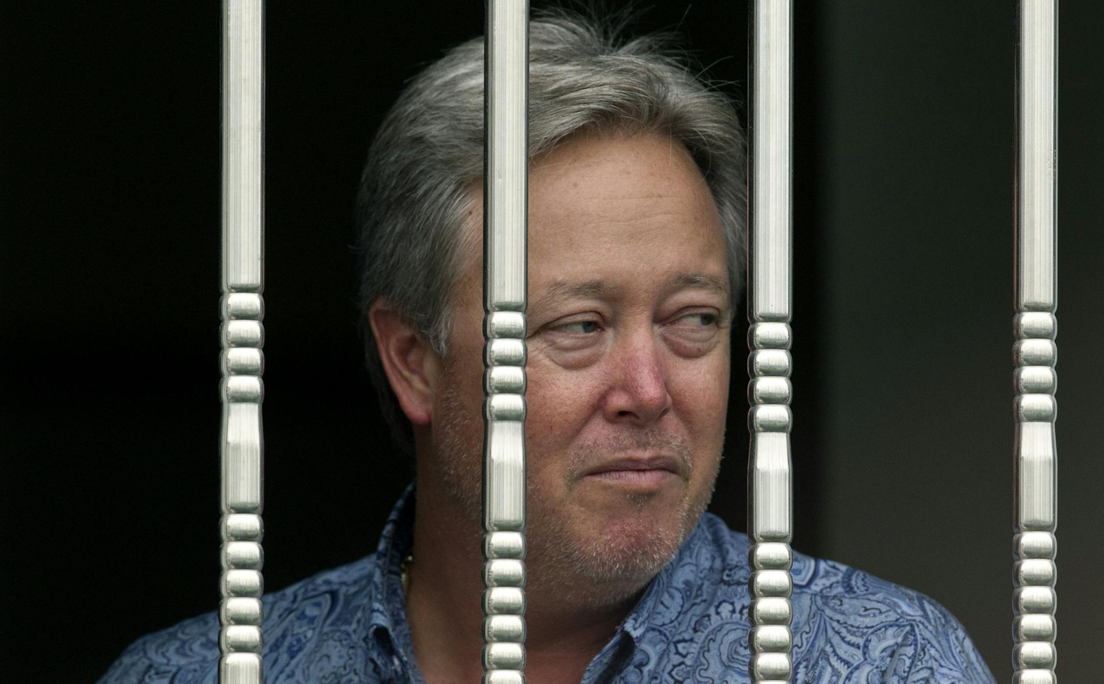American Chip Starnes, co-owner of Specialty Medical Supplies looks out from a window as he is held hostage by angry workers inside his plant at the Jinyurui Science and Technology Park in Qiao Zi township of Huairou District, on the outskirts of Beijing, China Tuesday, June 25, 2013. Starnes said he's waiting for his lawyers to arrive to resolve a compensation dispute that highlights tensions in China's labor market. (AP Photo/Andy Wong)