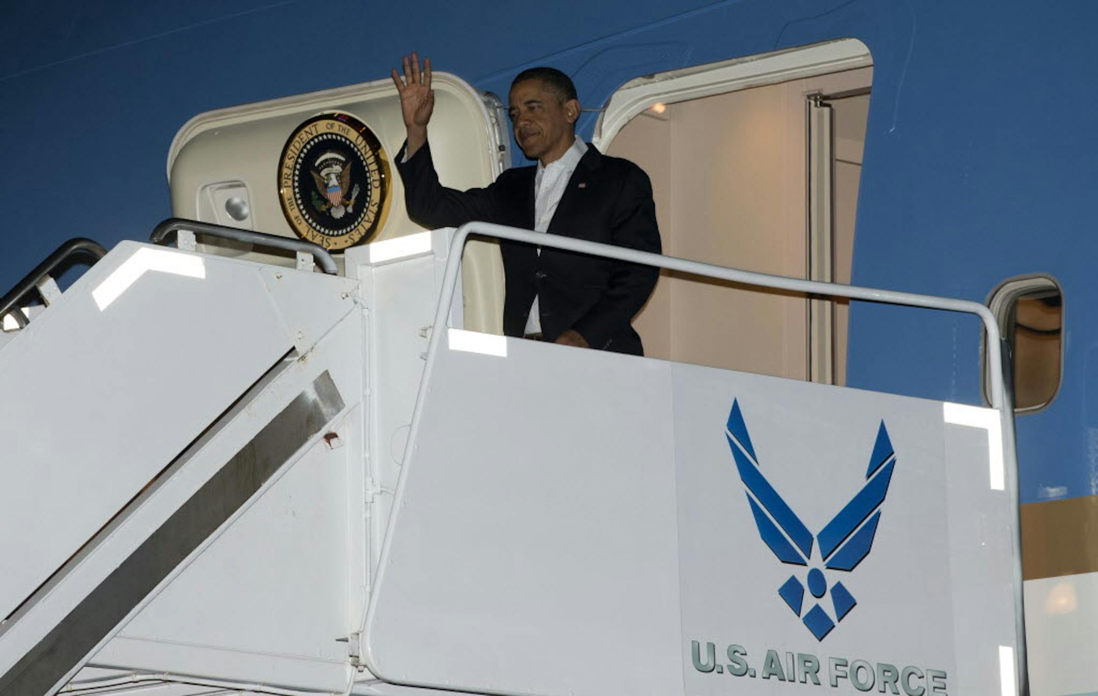 President Barack Obama gets off Air Force One upon his arrival at Joint Base Pearl Harbor-Hickam, Honolulu, Hawaii, Wednesday. The president is back in Hawaii for vacation.