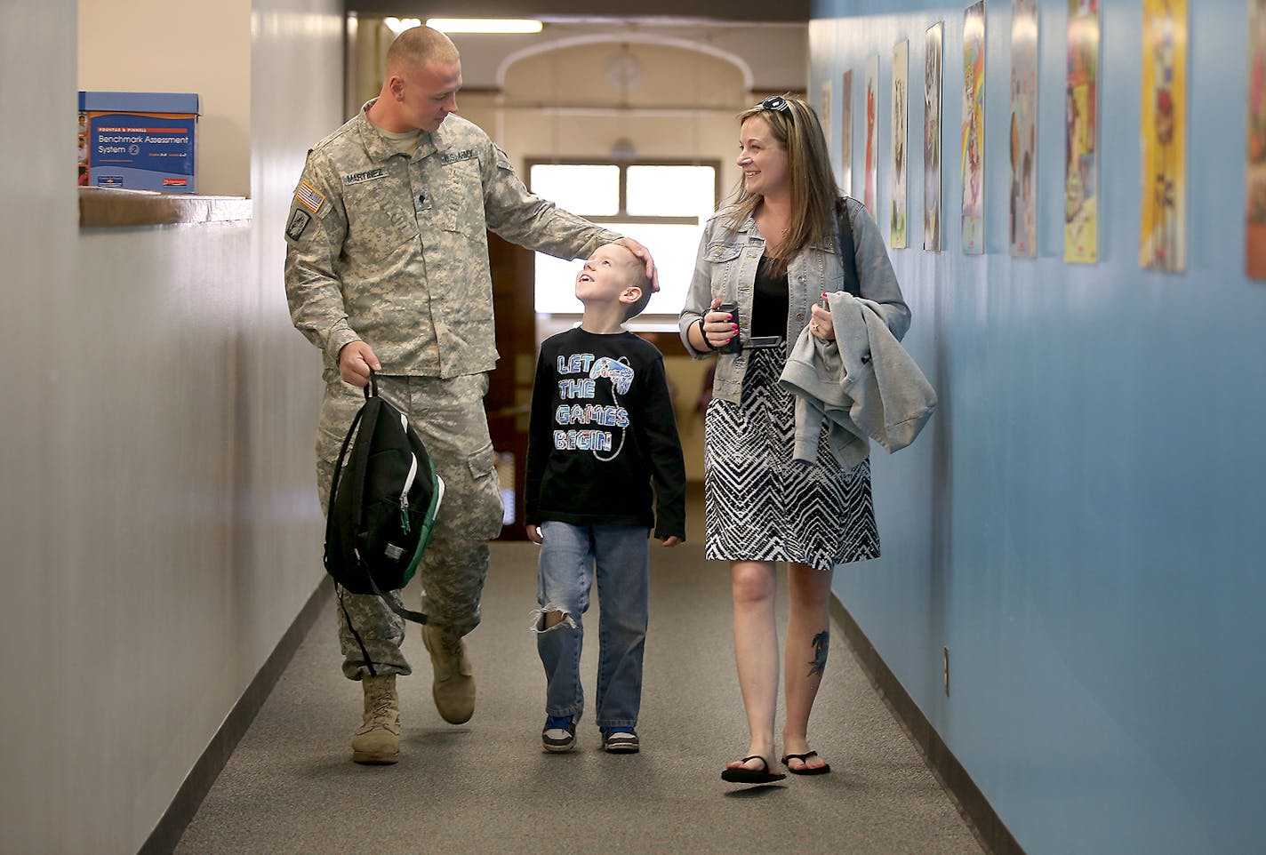 Hale Elementary School second-grader Jaden Martinez was more than happy to be picked up by his father Jacob Martinez and his mother Cassandra Martinez after surprising him at his class, Monday, April 27, 2015 in Minneapolis, MN. Martinez returned after a year in Kuwait and Iraq. ] (ELIZABETH FLORES/STAR TRIBUNE) ELIZABETH FLORES &#x2022; eflores@startribune.com