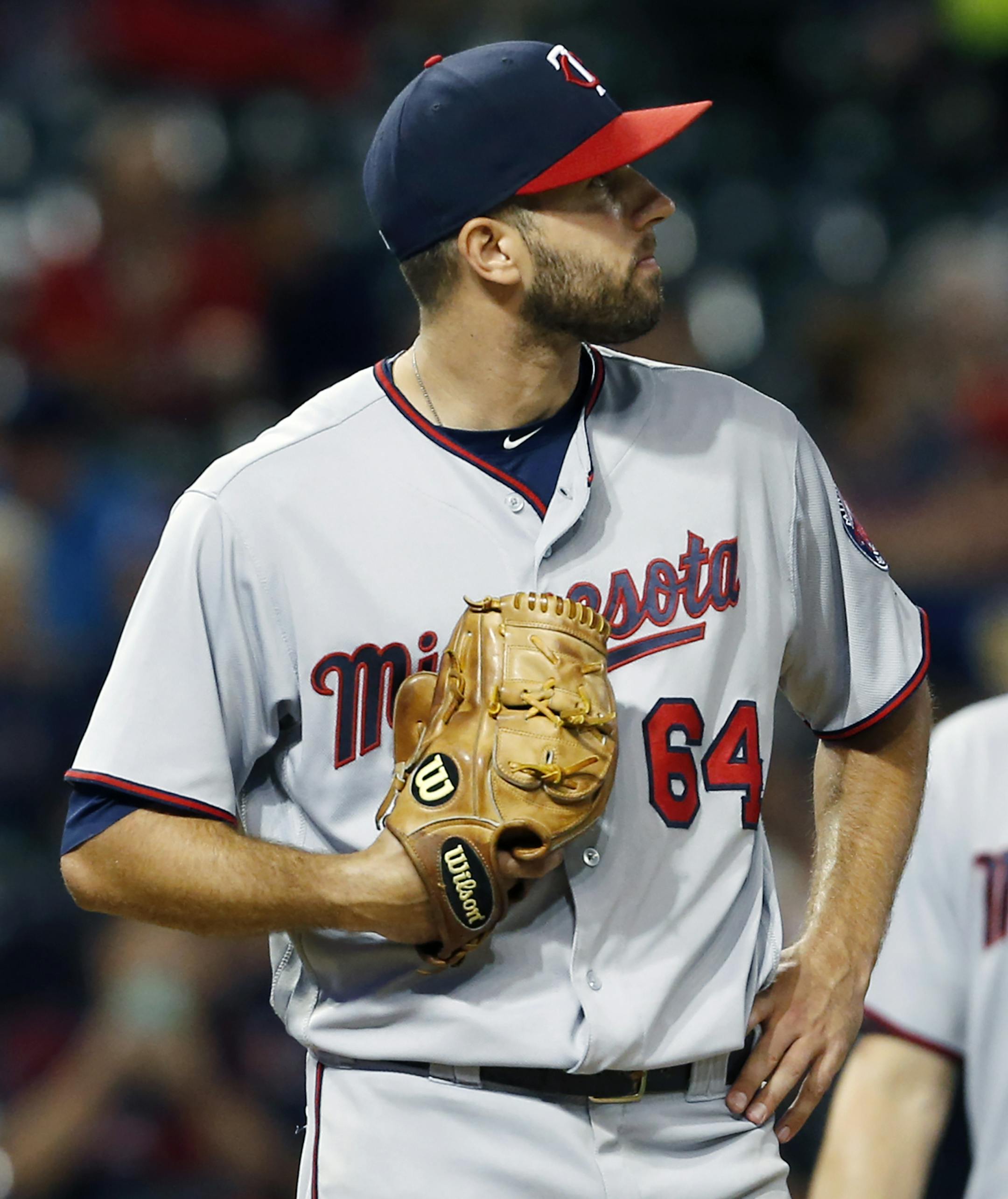 Minnesota Twins starting pitcher Pat Dean reacts after walking Cleveland Indians' Mike Napoli to load the bases during the fifth inning of a baseball game Wednesday, Aug. 31, 2016, in Cleveland. (AP Photo/Ron Schwane)