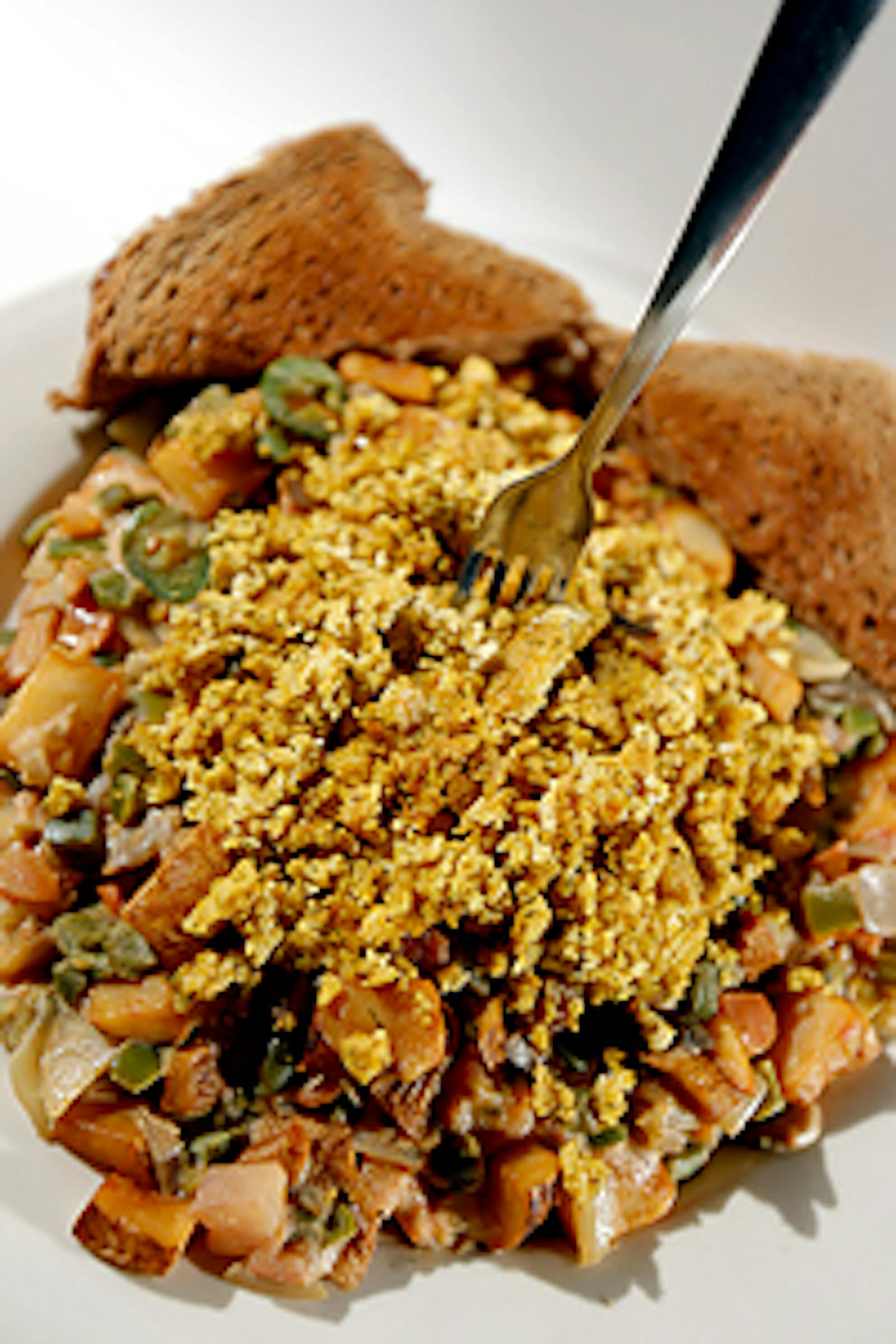 The "Mother Biker" at The Triple Rock Social Club is a Vegan dish that consists of potatoes, green peppers, tomatoes, onion, mushrooms, fresh jalapenos, Tofu scramble, and vegan nacho cheese sauce served with wheat toast.