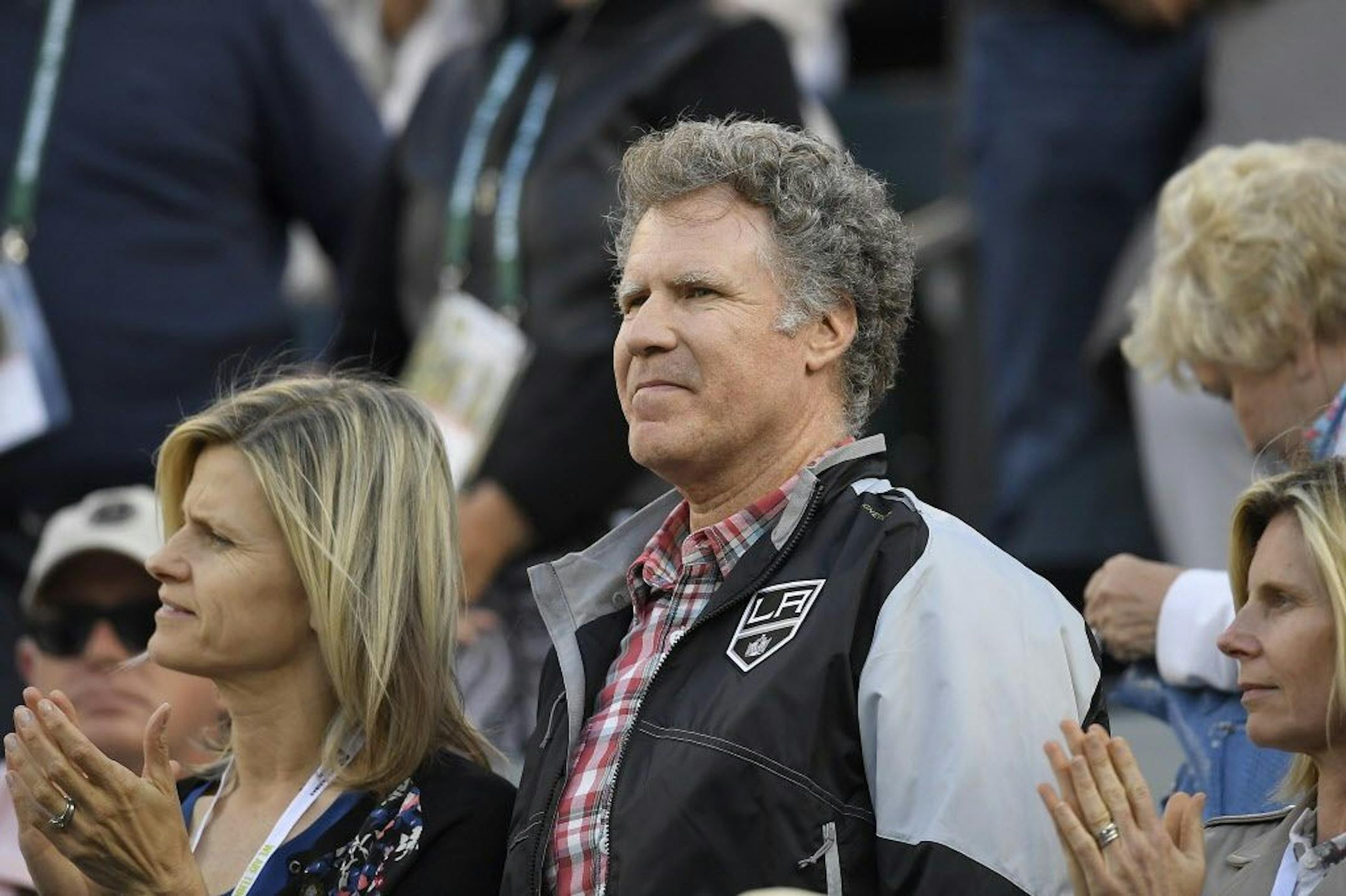 Actor Will Ferrell, center, watches a match at the BNP Paribas Open tennis tournament Wednesday, March 14, 2018, in Indian Wells, Calif.