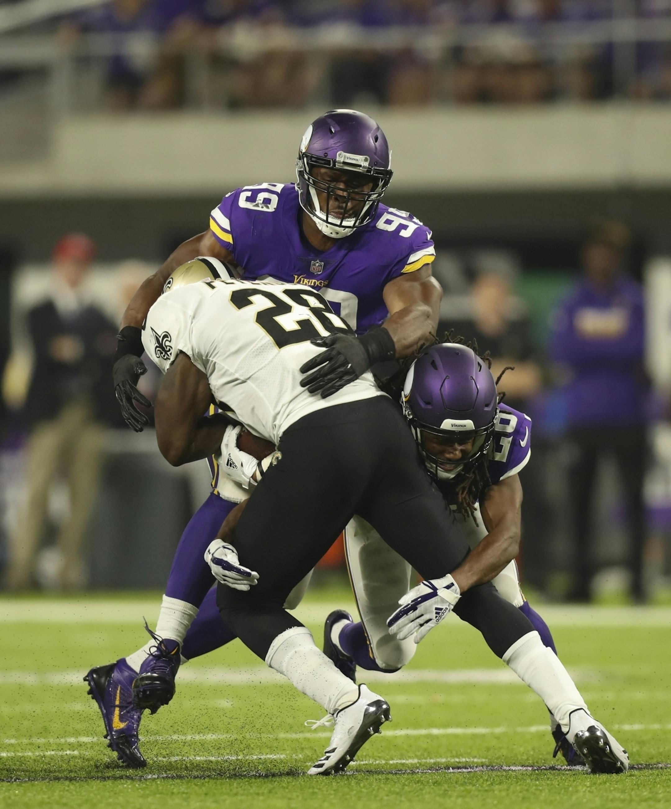 Minnesota Vikings defensive end Danielle Hunter (99) and Minnesota Vikings cornerback Trae Waynes (26) joined forces to stop New Orleans Saints running back Adrian Peterson (28) on a third quarter run.