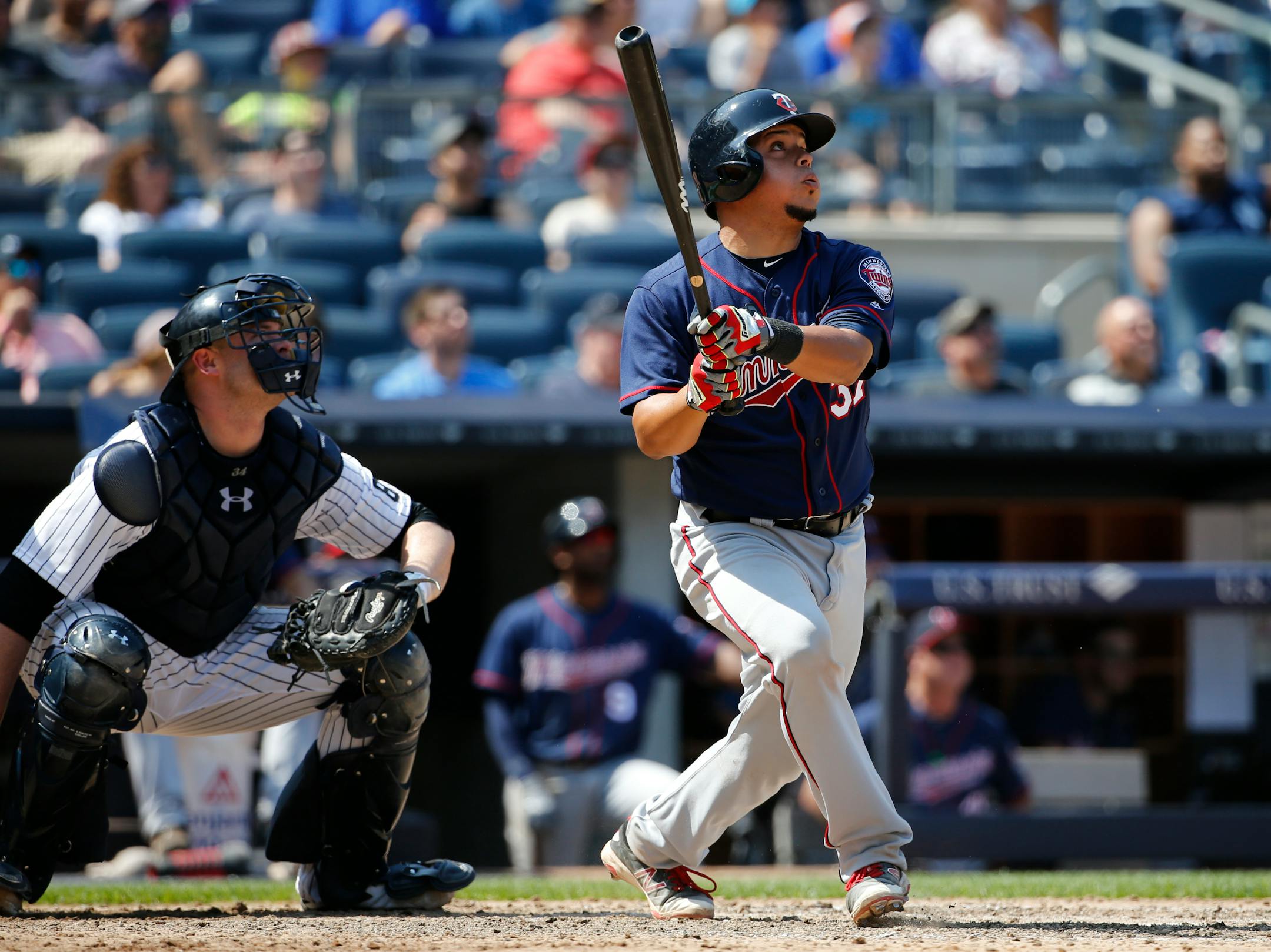 Minnesota Twins' Juan Centeno, right, watches his ninth-inning solo home run off New York Yankees relief pitcher Kirby Yates during a baseball game in New York, Sunday, June 26, 2016. Yankees catcher Brian McCann, left, also watches.