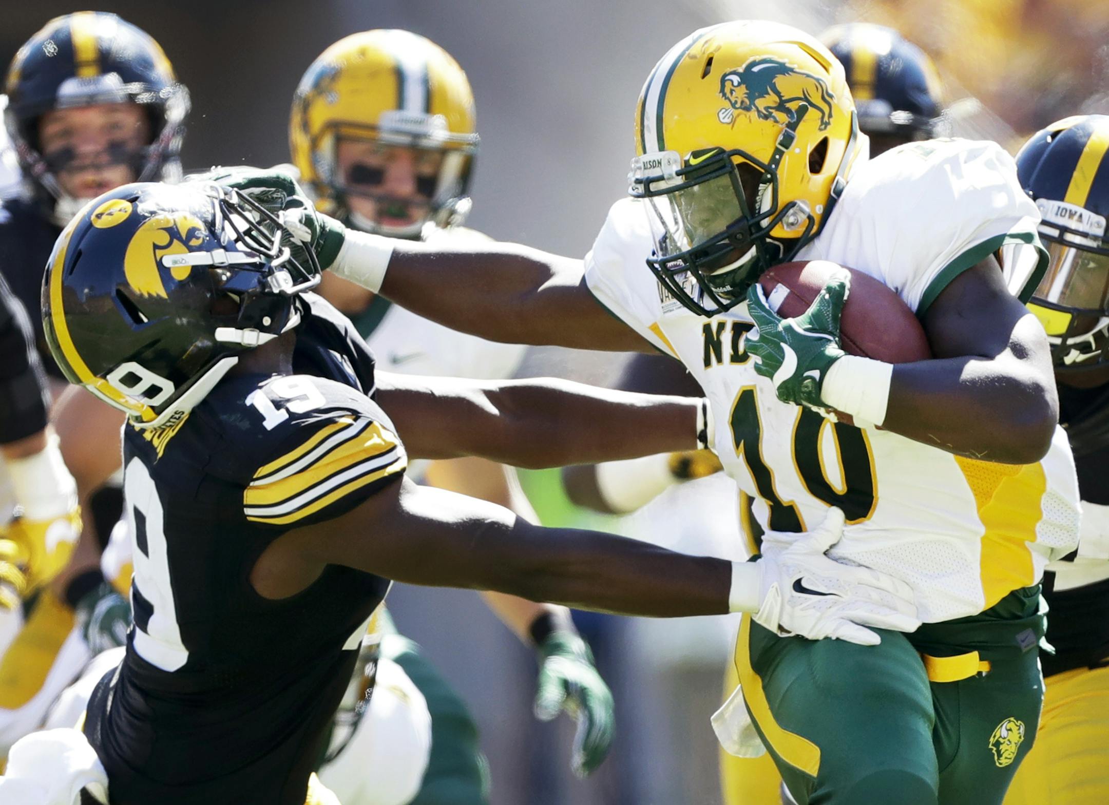 North Dakota State running back Lance Dunn, right, breaks a tackle by Iowa defensive back Miles Taylor, left, during the second half of an NCAA college football game, Saturday, Sept. 17, 2016, in Iowa City, Iowa. North Dakota State won 23-21. (AP Photo/Charlie Neibergall)
