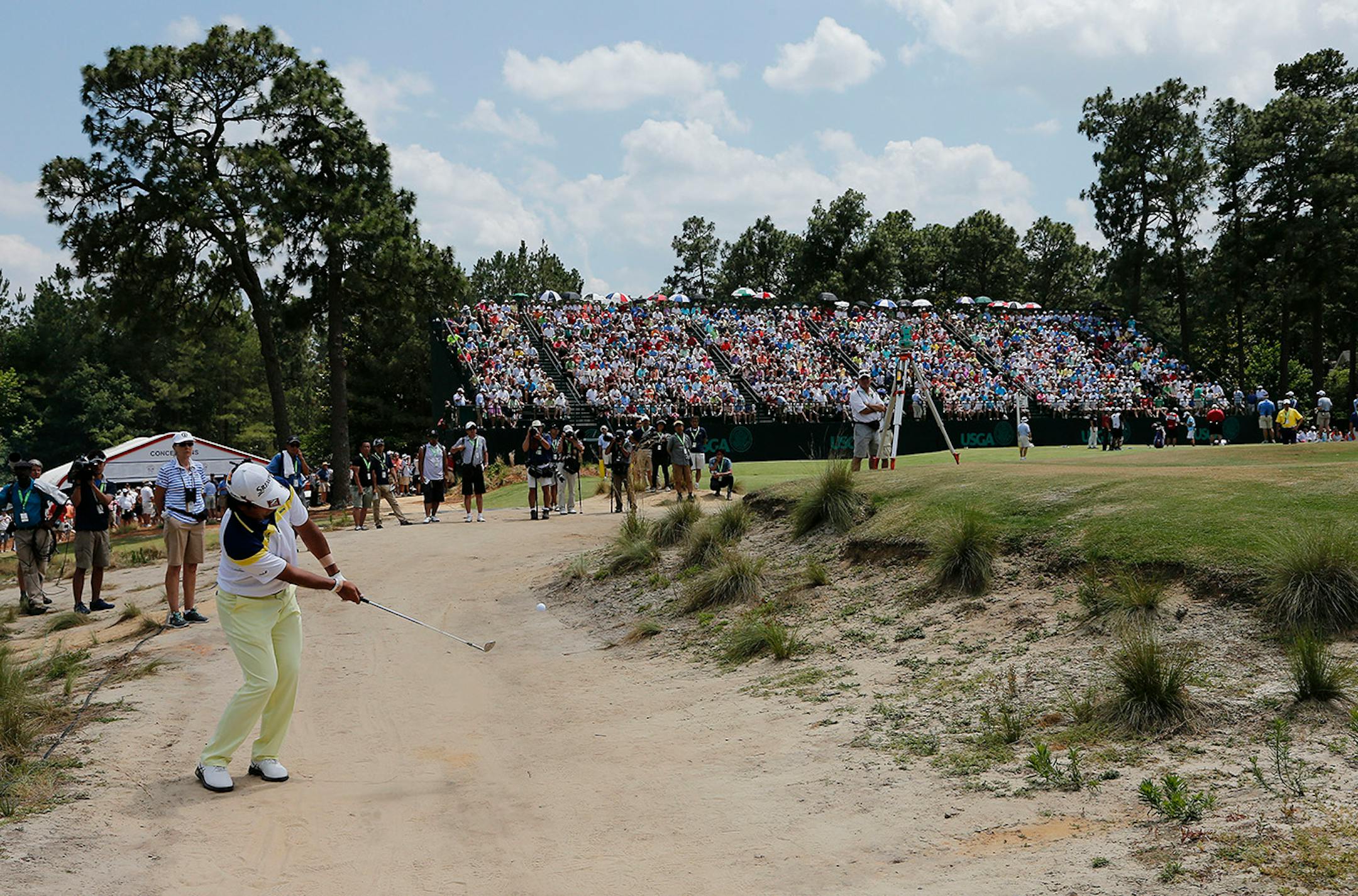 Hideki Matsuyama, of Japan, chips to the green on the third hole during the round of the U.S. Open golf tournament in Pinehurst, N.C., Saturday, June 14, 2014.