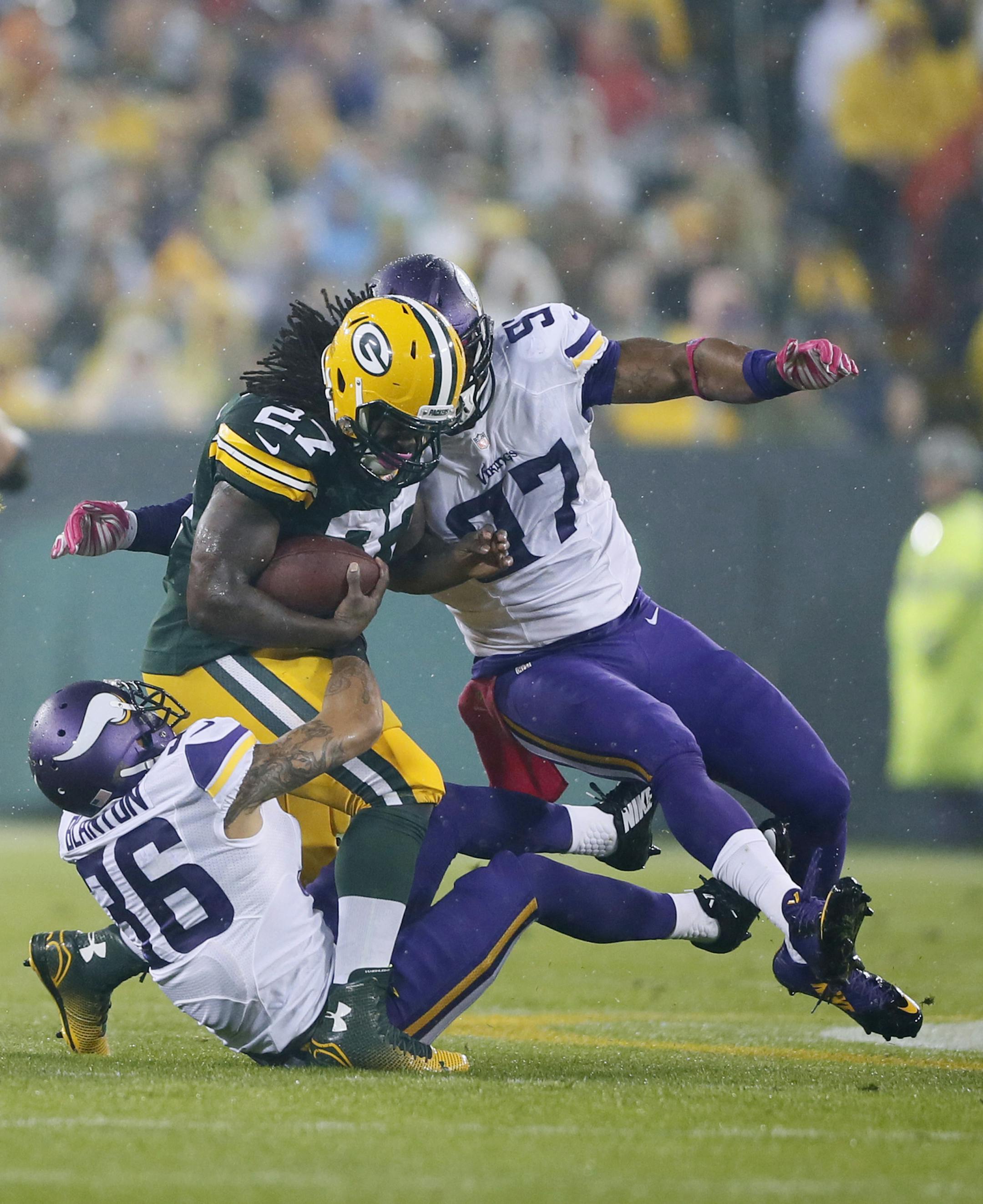 Green Bay Packers running back Eddie Lacy (27) was tackled by Minnesota Vikings strong safety Robert Blanton (36) and Minnesota Vikings defensive end Everson Griffen (97) in the first quarter. The Minnesota Vikings played the Green Bay Packers Thursday October 2 , 2014 at Lambeau Field in Green Bay ,WI. ] Jerry Holt Jerry.holt@startribune.com