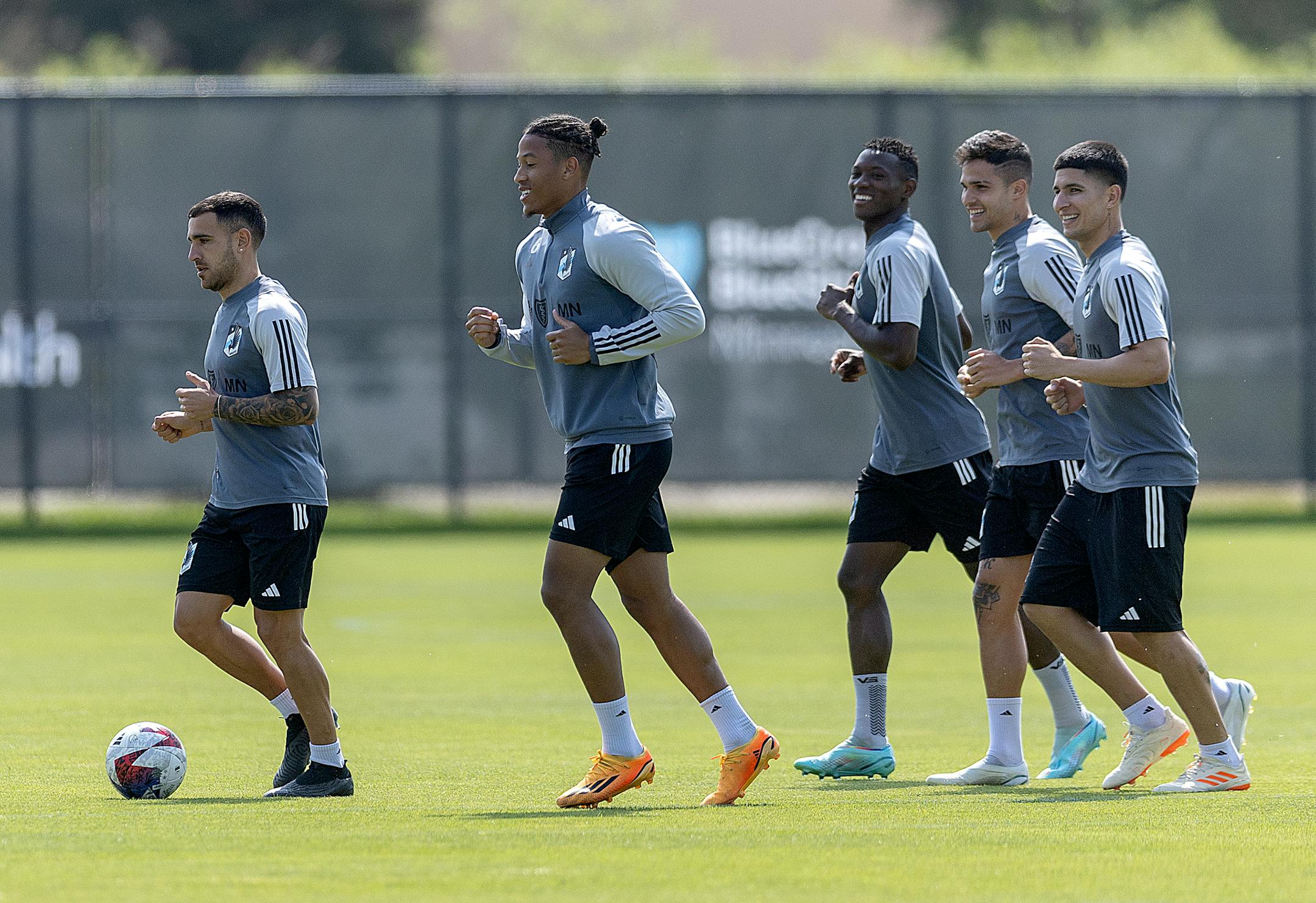Minnesota United players warm up before a brief practice at the National Sports Center in Blaine, Minn.
