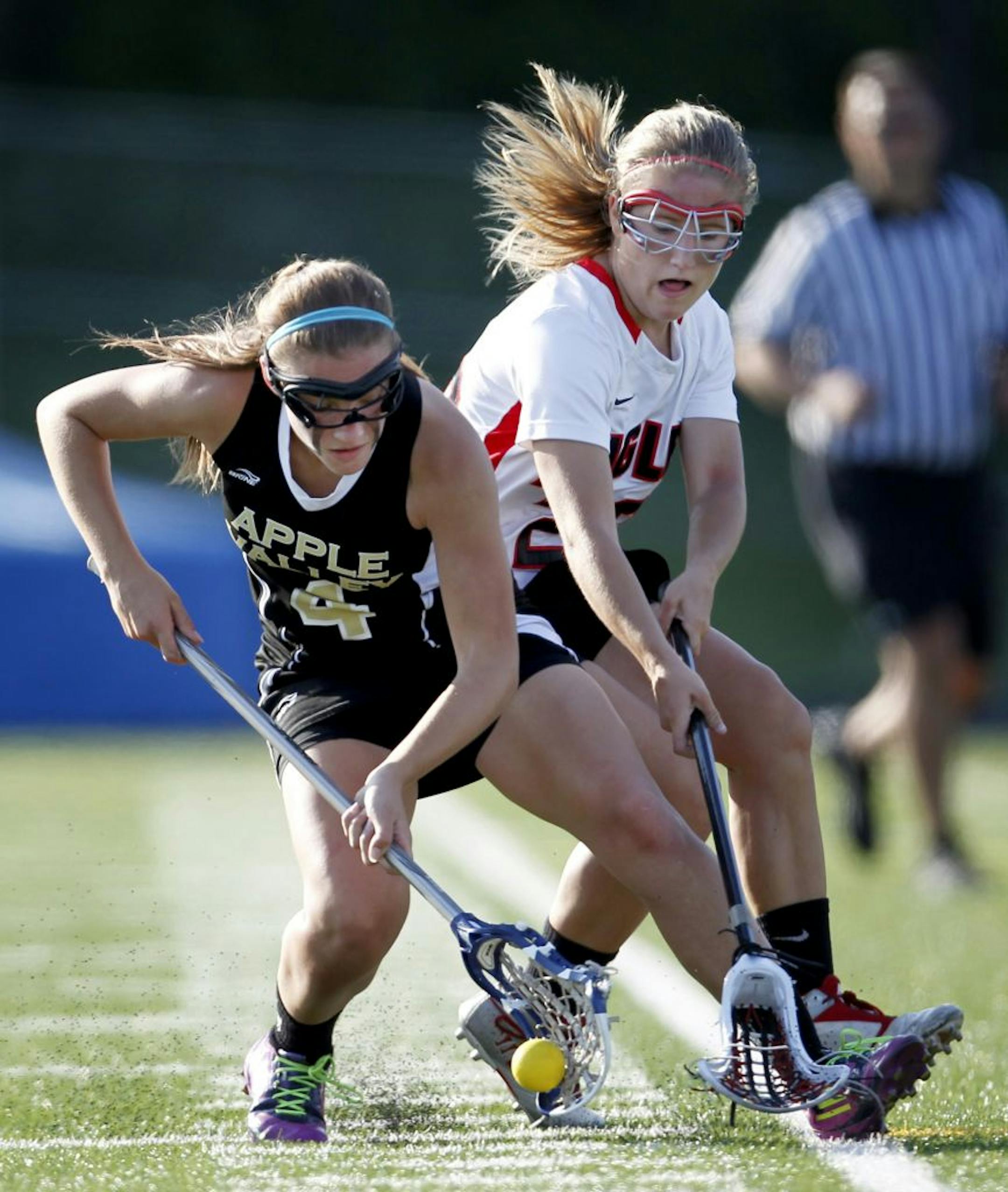 Apple Valley's Katie Larson (4) and Eden Prairie's Christine Easton (23) fought for a loose ball in the first half.