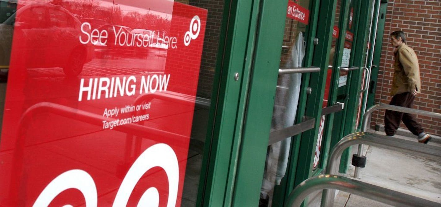 A sign announces that a Target store is hiring workers in Framingham, Mass. , Thursday, Dec. 23, 2010. Economic reports Thursday suggest employers are laying off fewer workers, businesses are ordering more computers and appliances, and consumers are spending with more confidence.