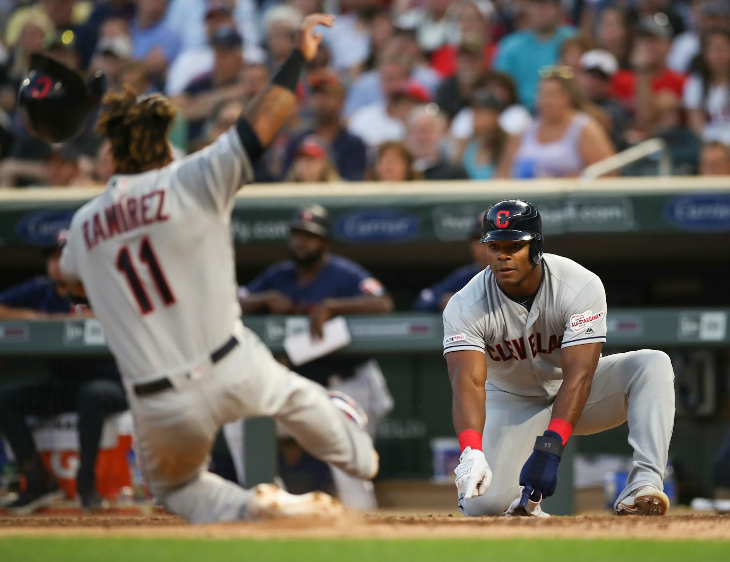 Cleveland right fielder Yasiel Puig indicated for teammate Jose Ramierez to slide when they both scored in the fourth inning.