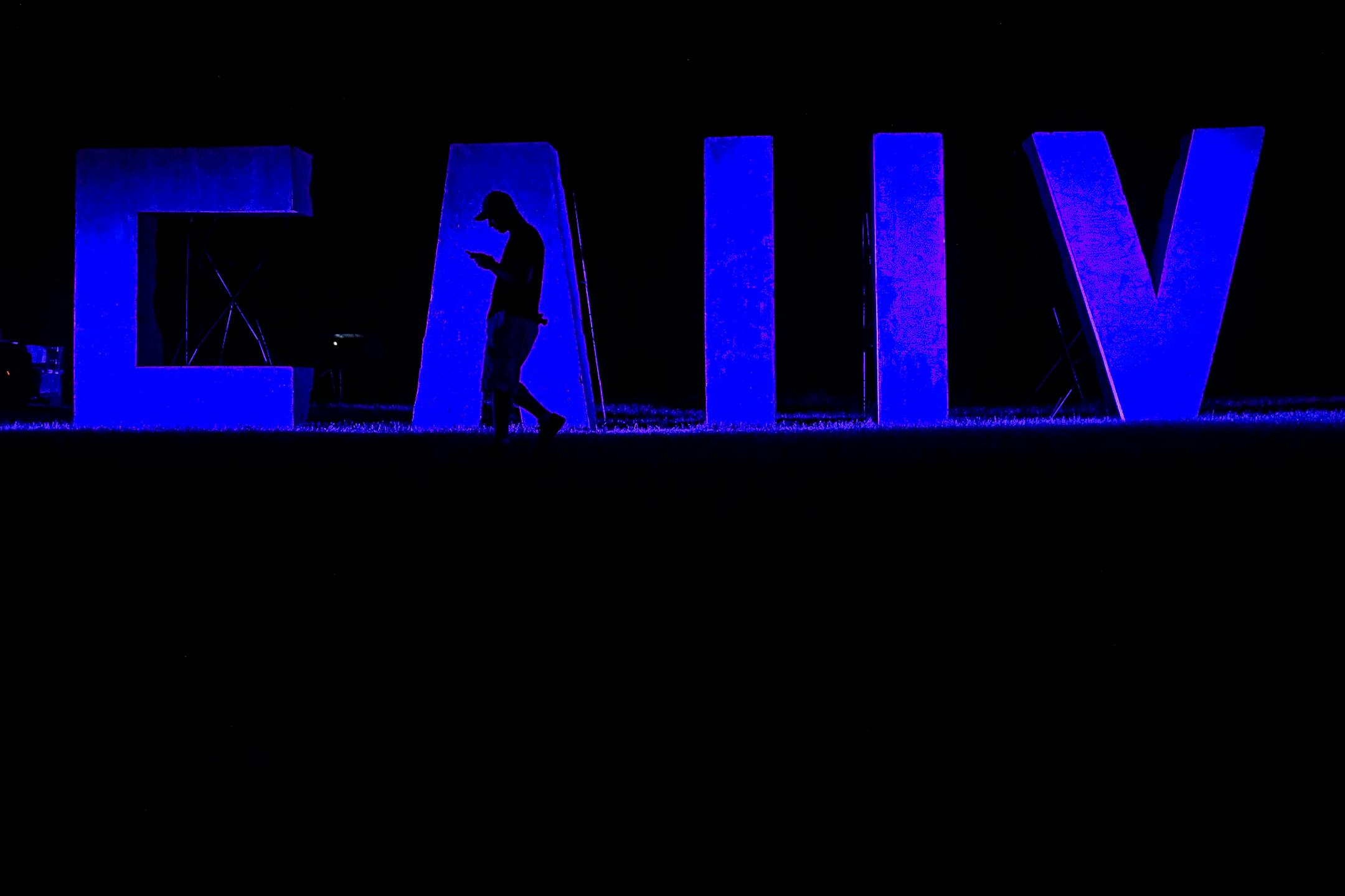 A man passed by a sculpture while checking his cell phone Saturday at the Eaux Claires Music and Art Festival. ] AARON LAVINSKY ï aaron.lavinsky@startribune.com Day two of the Eaux Claires Music & Art Festival was held Saturday, July 7, 2018 at Foster Farms in Eau Claire, Wisc.