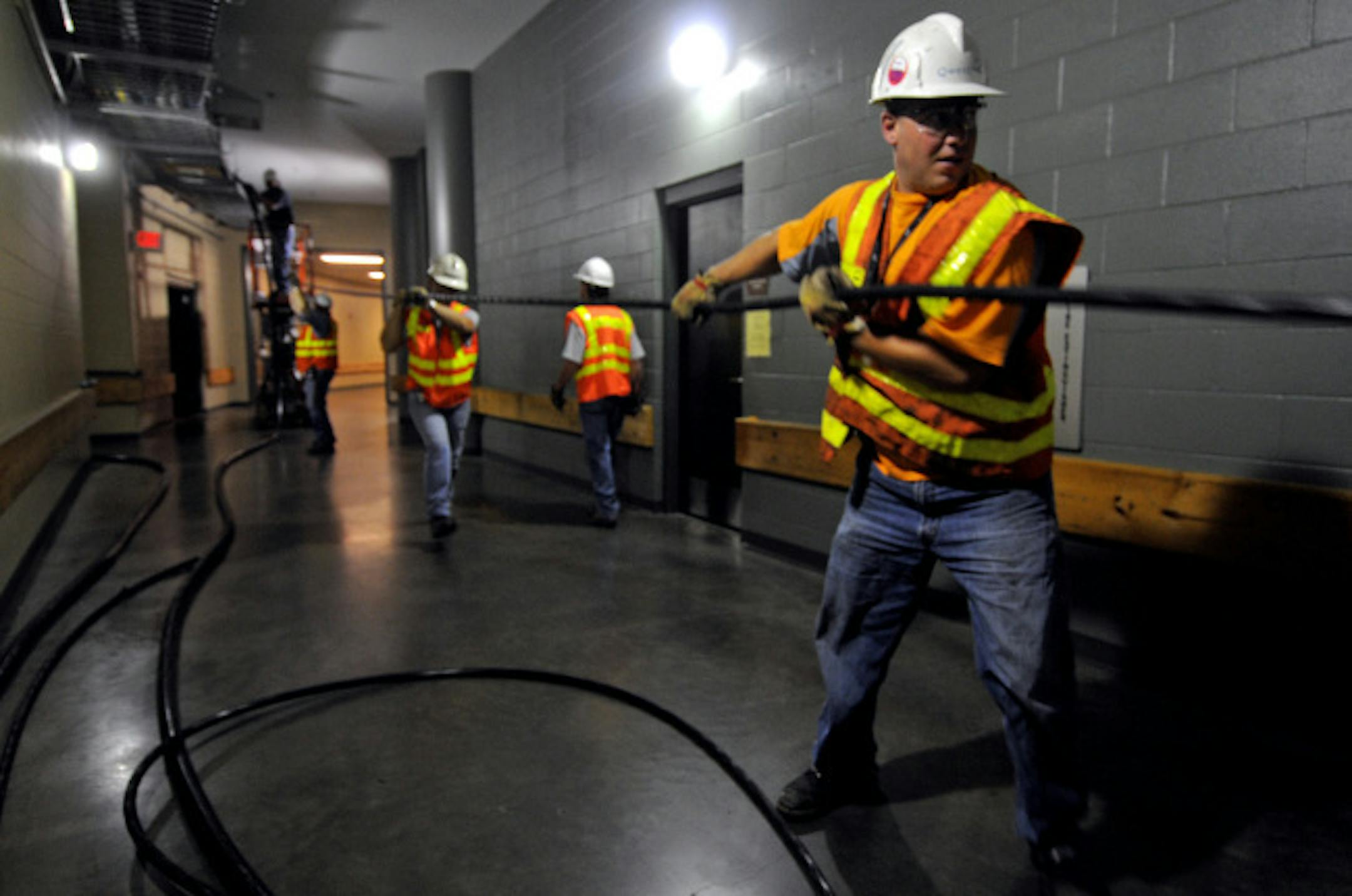 Workers at the Xcel Energy Center in St. Paul on Monday began installing more than 6 miles of cable for the upcoming Republican National Convention.