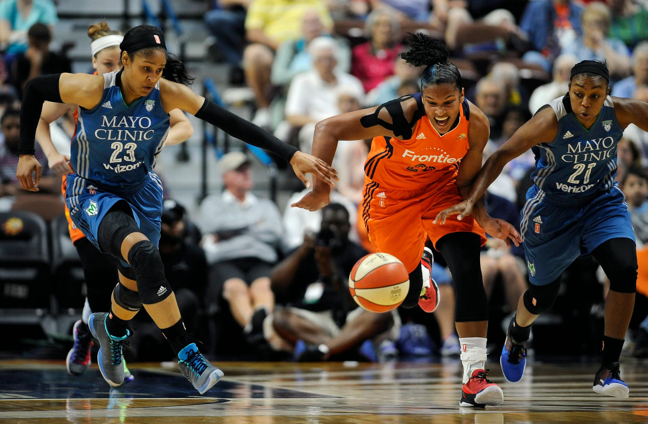 Minnesota Lynx' Maya Moore, left, and Renee Montgomery, right, pursue Connecticut Sun's Alyssa Thomas during the first half of a WNBA basketball game, Thursday, July 7, 2016, in Uncasville, Conn. (AP Photo/Jessica Hill)