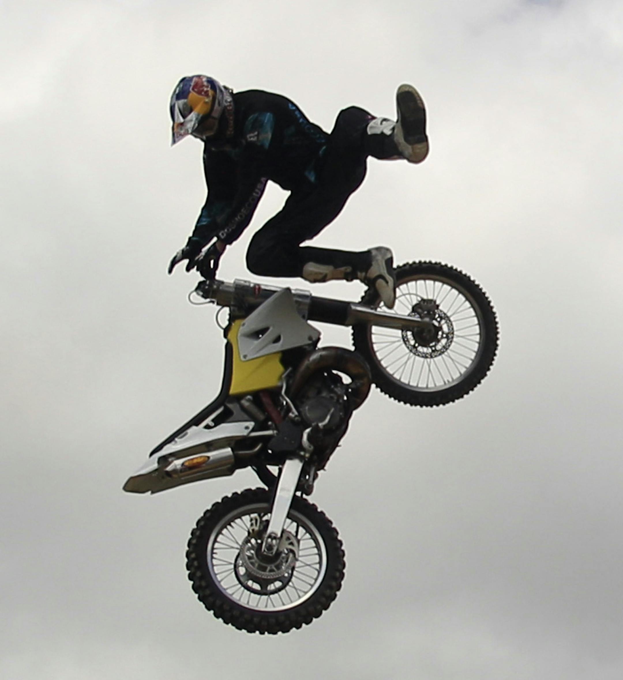 In this May 29, 2011 photo, action sports star Travis Pastrana does a stunt on his motorcycle to prepare for an upcoming performance at the Nitro Circus practice grounds in Pala, Calif. After playing to big crowds Down Under, Pastrana unleashes his Nitro Circus Live on North America with a Saturday night show in Las Vegas.(AP Photo/Lenny Ignelzi) ORG XMIT: CALI205