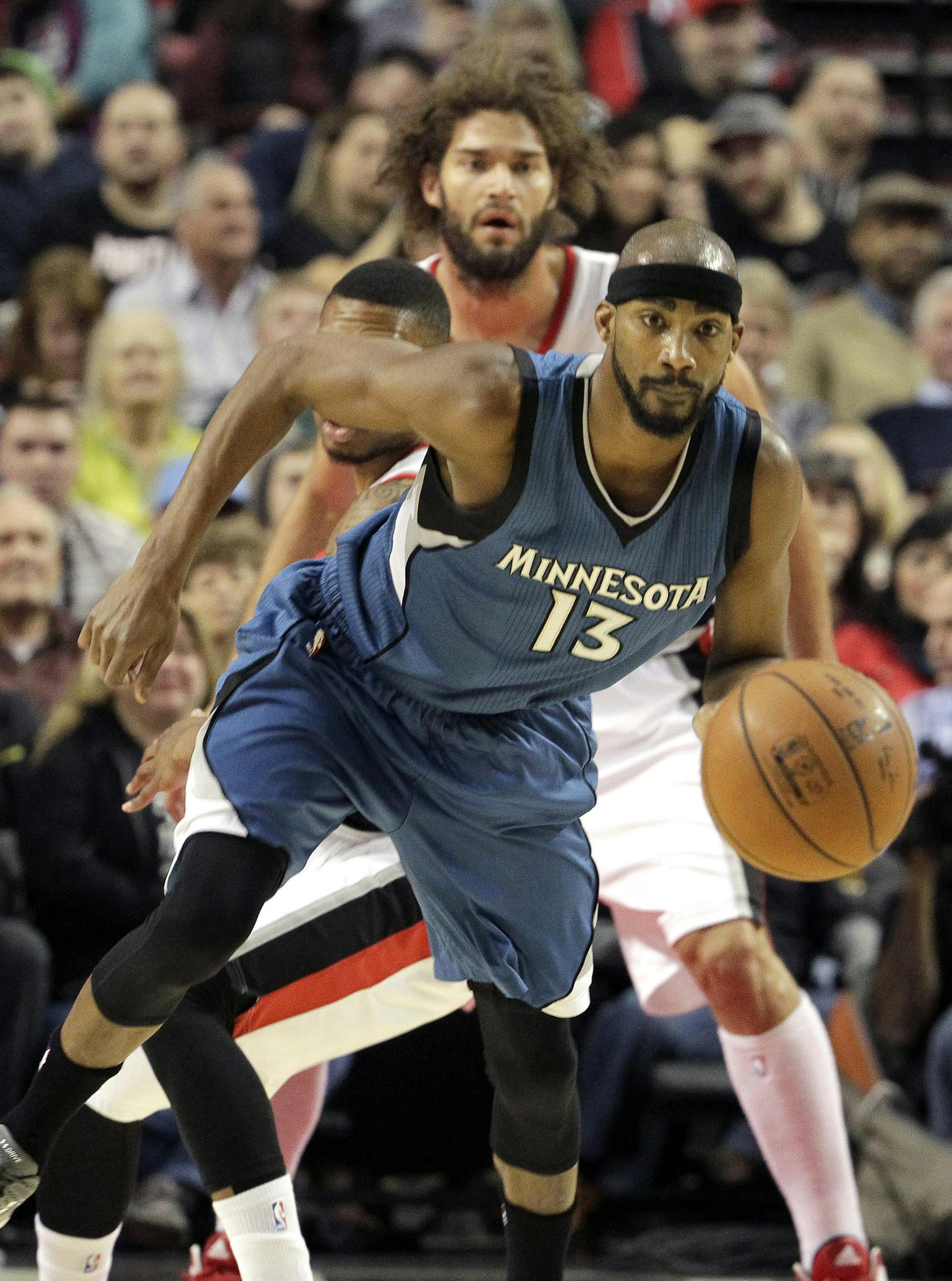 Minnesota Timberwolves guard Corey Brewer chases down a loose ball as the Portland Trail Blazers trail from behind during the first half of an NBA basketball game in Portland, Ore., Sunday, Nov. 30, 2014. (AP Photo/Don Ryan)