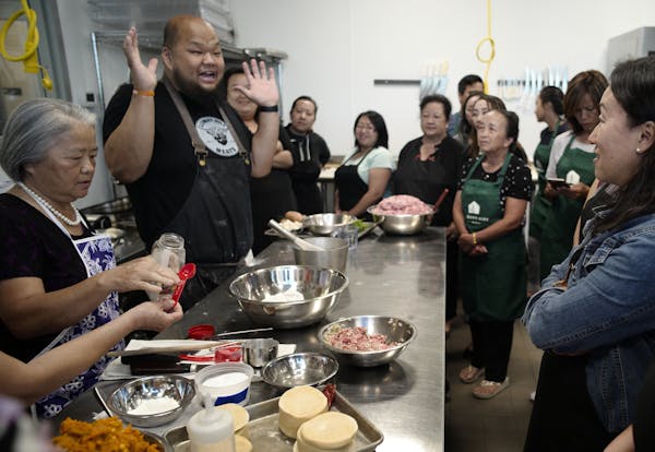 Yia Vang, center in black apron, of the pop-up Union Kitchen, taught the class with his mother, Pang Vang, at left.