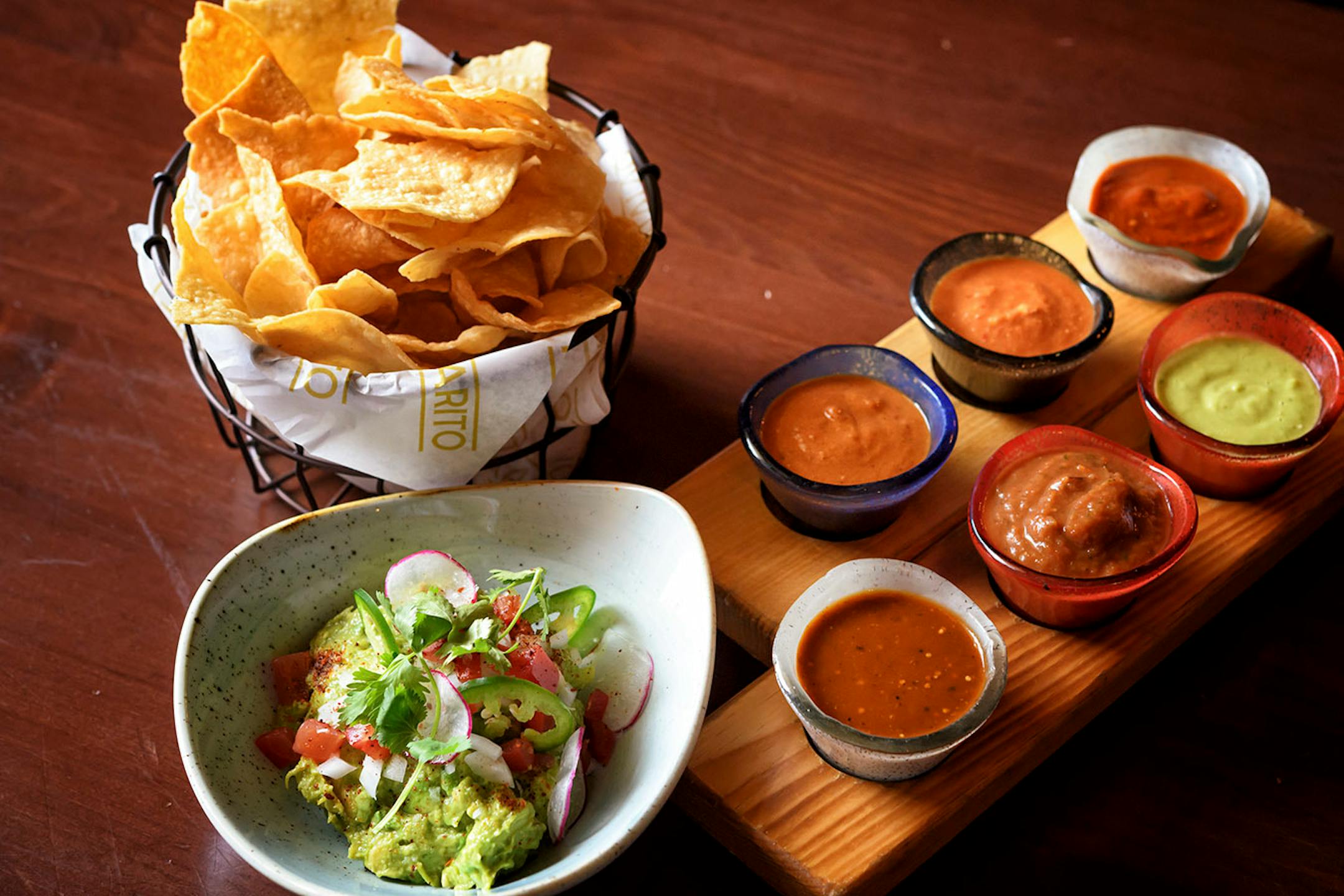Salsa and chips — Ancho-Guajillo, Charred Tomato, Avocado-Serrano, Arbol Cashew, Chipotle, Habanero. Guacamole.