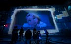 Guests watch animation projected on all walls and the floor during the Lighthouse Immersive Studio's Immersive Disney Animation in Minneapolis, Minn.,