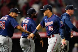Minnesota Twins third baseman Gio Urshela (15) celebrates with teammates after a 4-0 win over the Los Angeles Angels in a baseball game in Anaheim, Ca