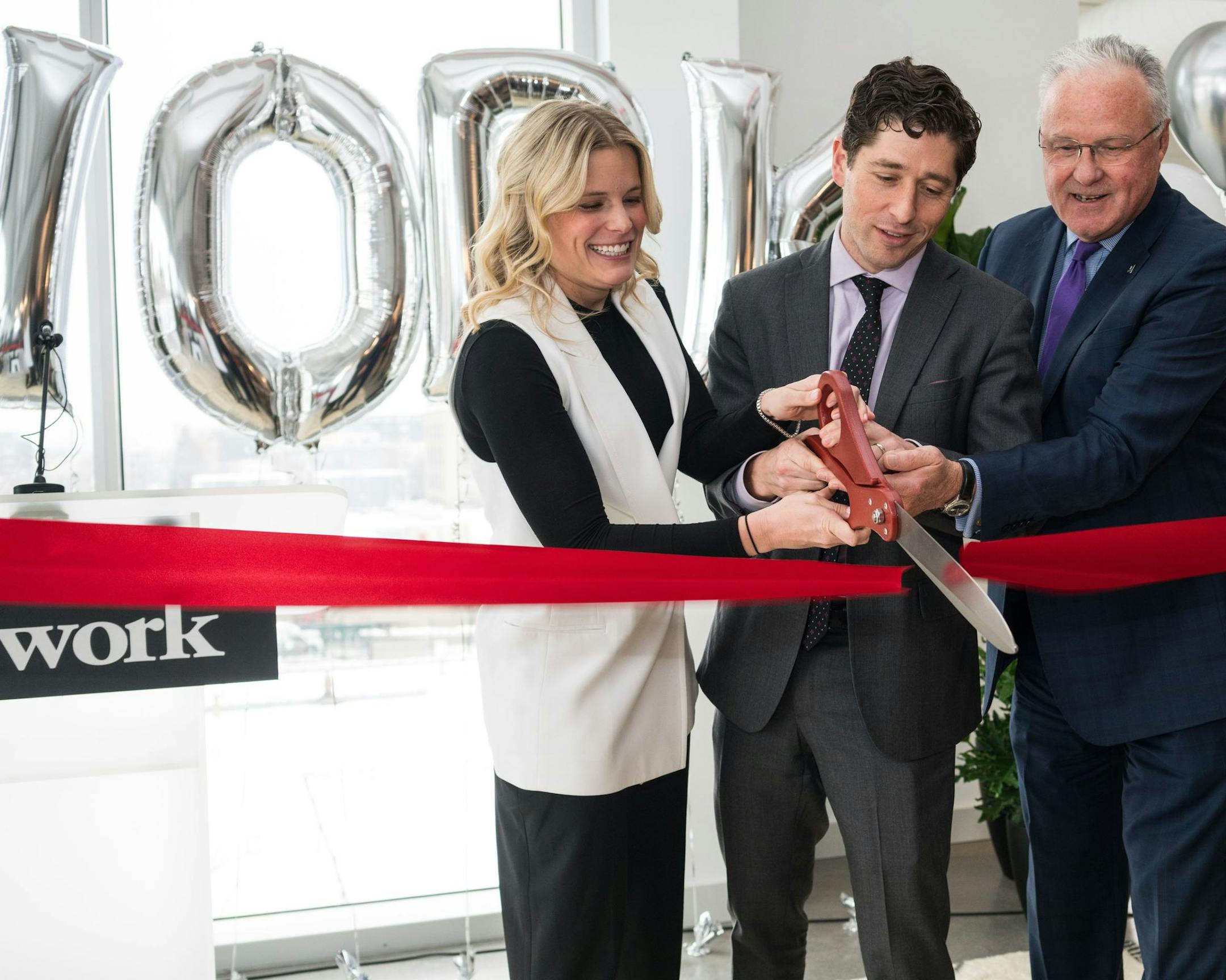Mayor Jacob Frey was on hand for the grand opening of WeWork's new coworking space in Uptown in December. Also pictured are Megan Dodds, WeWork Midwest general manager, and Michael Langley, chief executive of Greater MSP. Photo courtesy WeWork