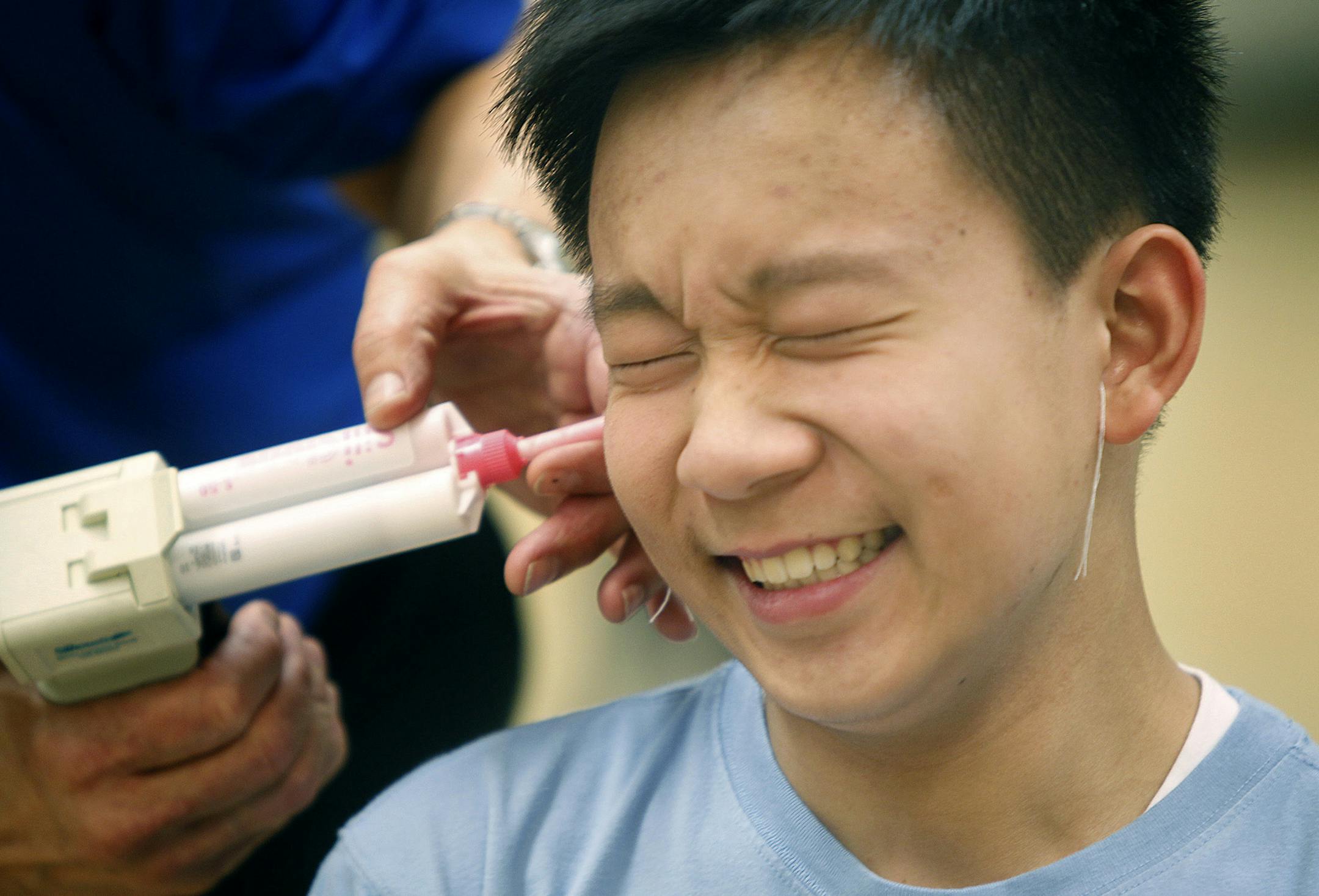 Matthew Lim, 14, joined hundreds of band members at Eagan High School that were fitted for custom made noise protection devices to combat the problems with hearing loss in teens, Wednesday, February 13, 2013 in Eagan, MN. (ELIZABETH FLORES/STAR TRIBUNE) ELIZABETH FLORES ¬• eflores@startribune.com ORG XMIT: MIN1302131551272130