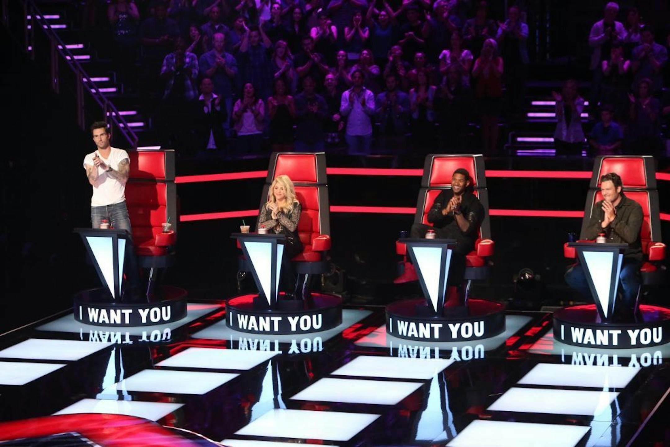 This undated image released by NBC shows mentors, from left, Adam Levine, Shakira, Usher, and Blake Shelton on the set of the singing competition series, "The Voice," in Los Angeles. "The Voice" begins its new season 8 p.m. EDT Monday, March 25, with another two-hour episode. NBC said Monday that the show will double to two hours on April 30 and May 7 to showcase pivotal rounds in the singing competition.