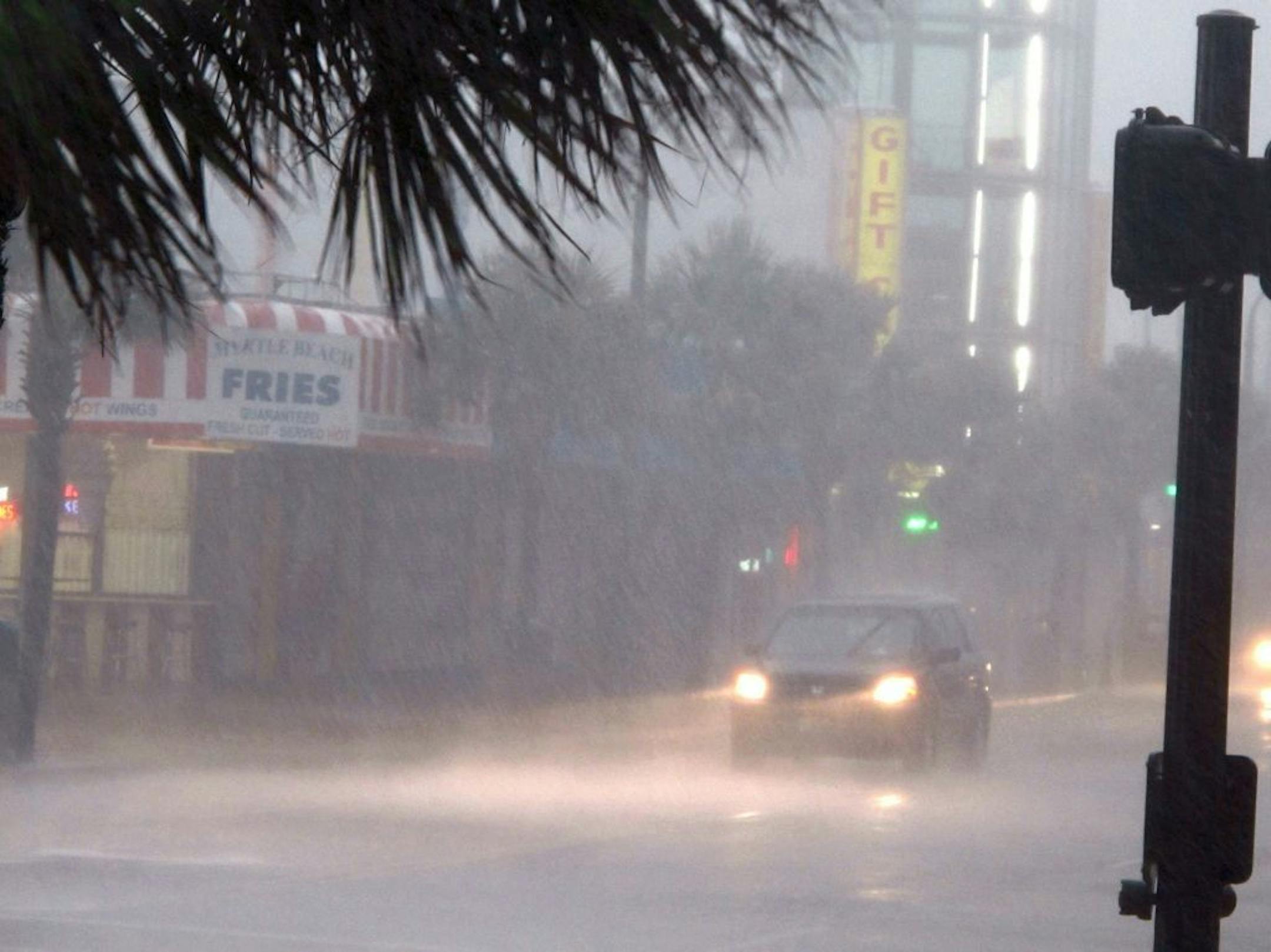 A downpour from Hurricane Irene slows traffic in downtown Myrtle Beach, S.C., on Friday, Aug. 26, 2011. Irene has the potential to cause billions of dollars in damage all along a densely populated arc that includes Washington, Baltimore, Philadelphia, New York, Boston and beyond. At least 65 million people could be affected.