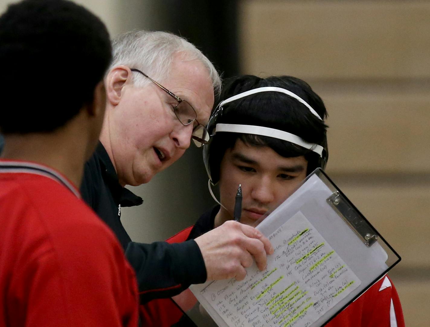 Eden Prairie's head coach Scot Davis talked with wrestler Ben Matsui before his match. ] (KYNDELL HARKNESS/STAR TRIBUNE) kyndell.harkness@startribune.com Triangle meet Wayzata vs Edina vs Eden Prairie in Plymouth Min., Thursday, January 8, 2014.