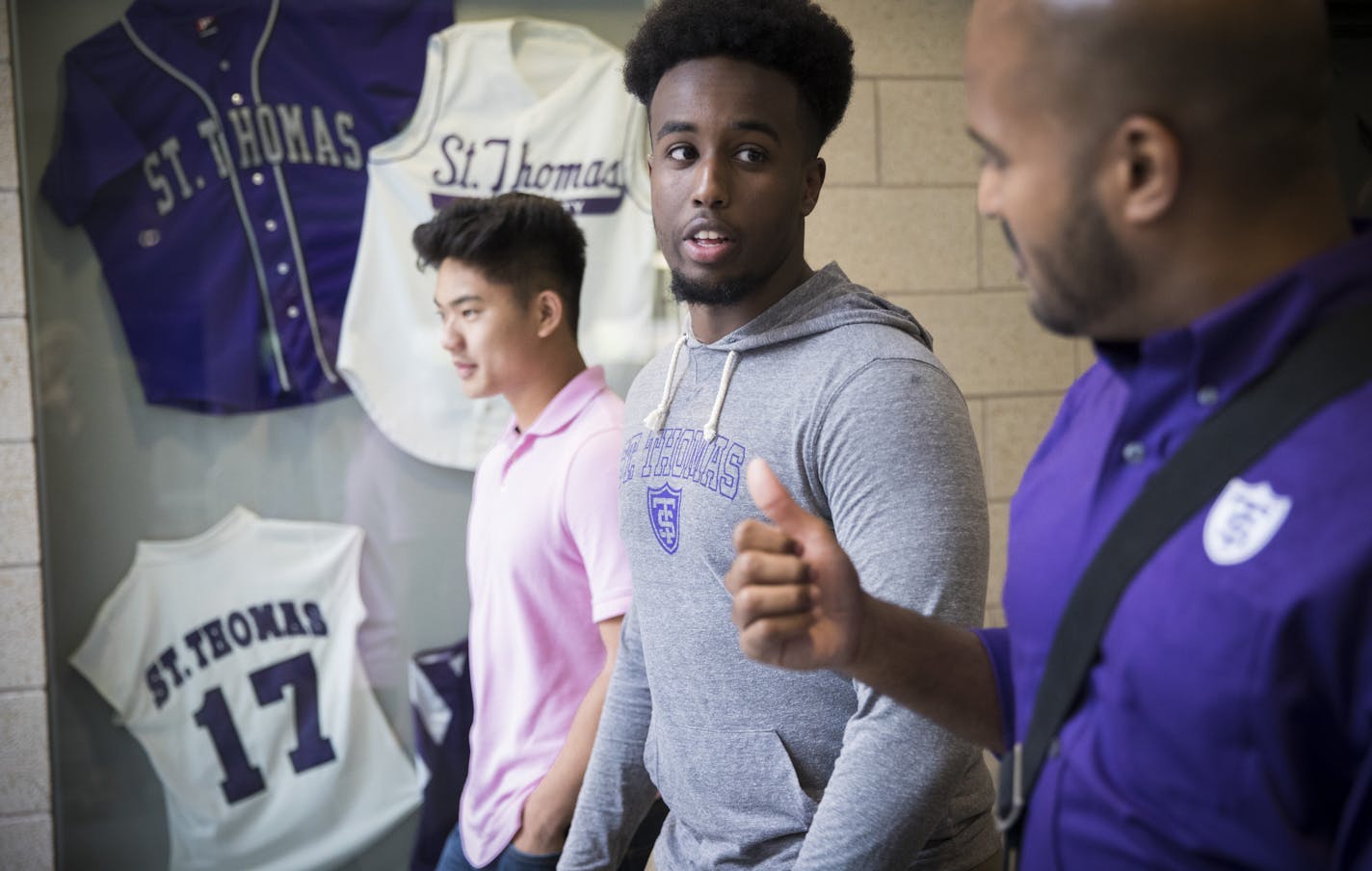 Future Dougherty Family College students Brian Ngo and Zakaria Elmi chat with dean Alvin Abraham during a tour Friday. The new two-year school at the Univeristy of St. Thomas will cost as little as $1,000 a year for the neediest students.