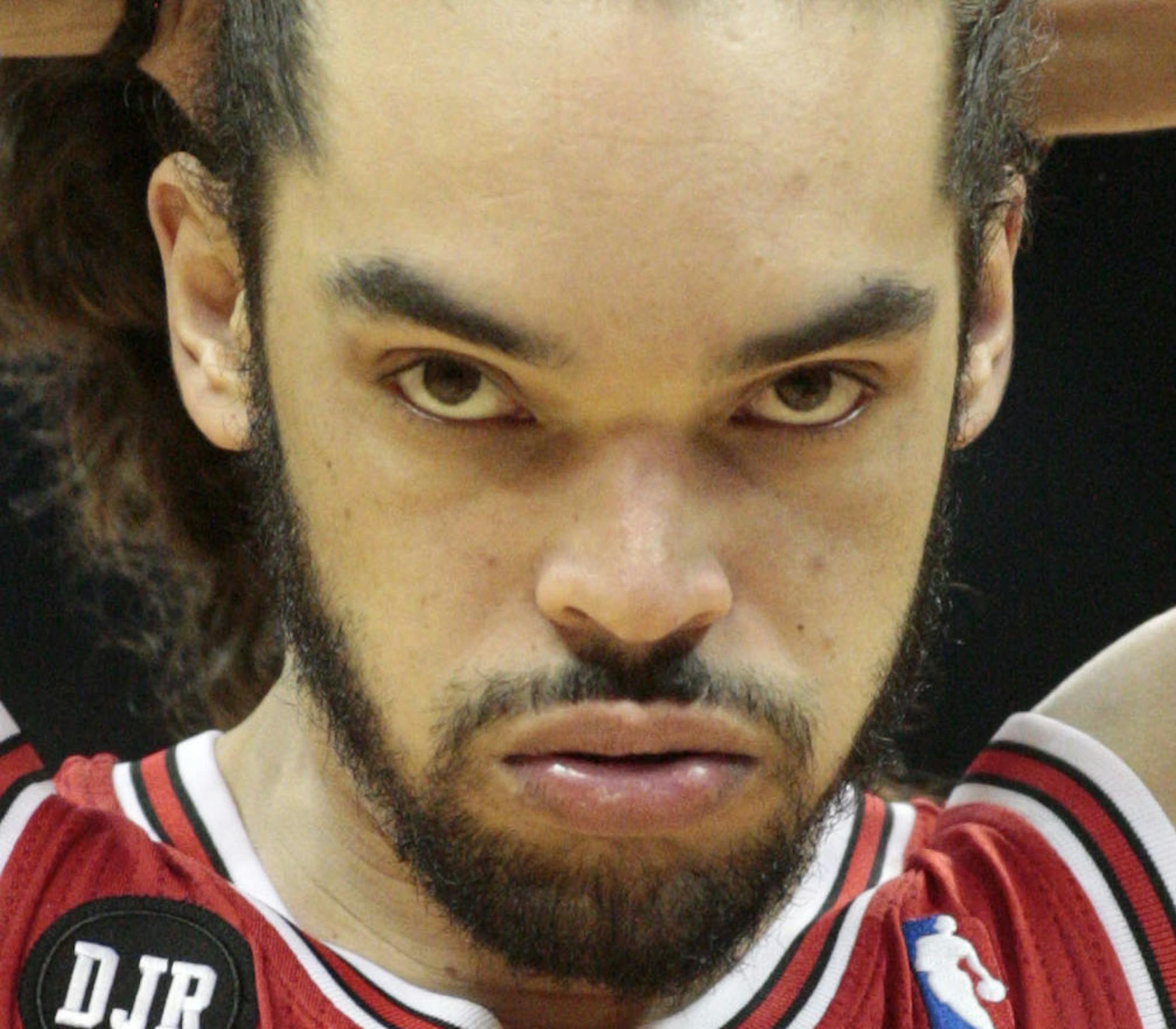Chicago Bulls center Joakim Noah (13) adjusts his hair before an NBA basketball game against the Atlanta Hawks Wednesday, April 2, 2014, in Atlanta. The Bulls won 105-92. (AP Photo/Jason Getz)