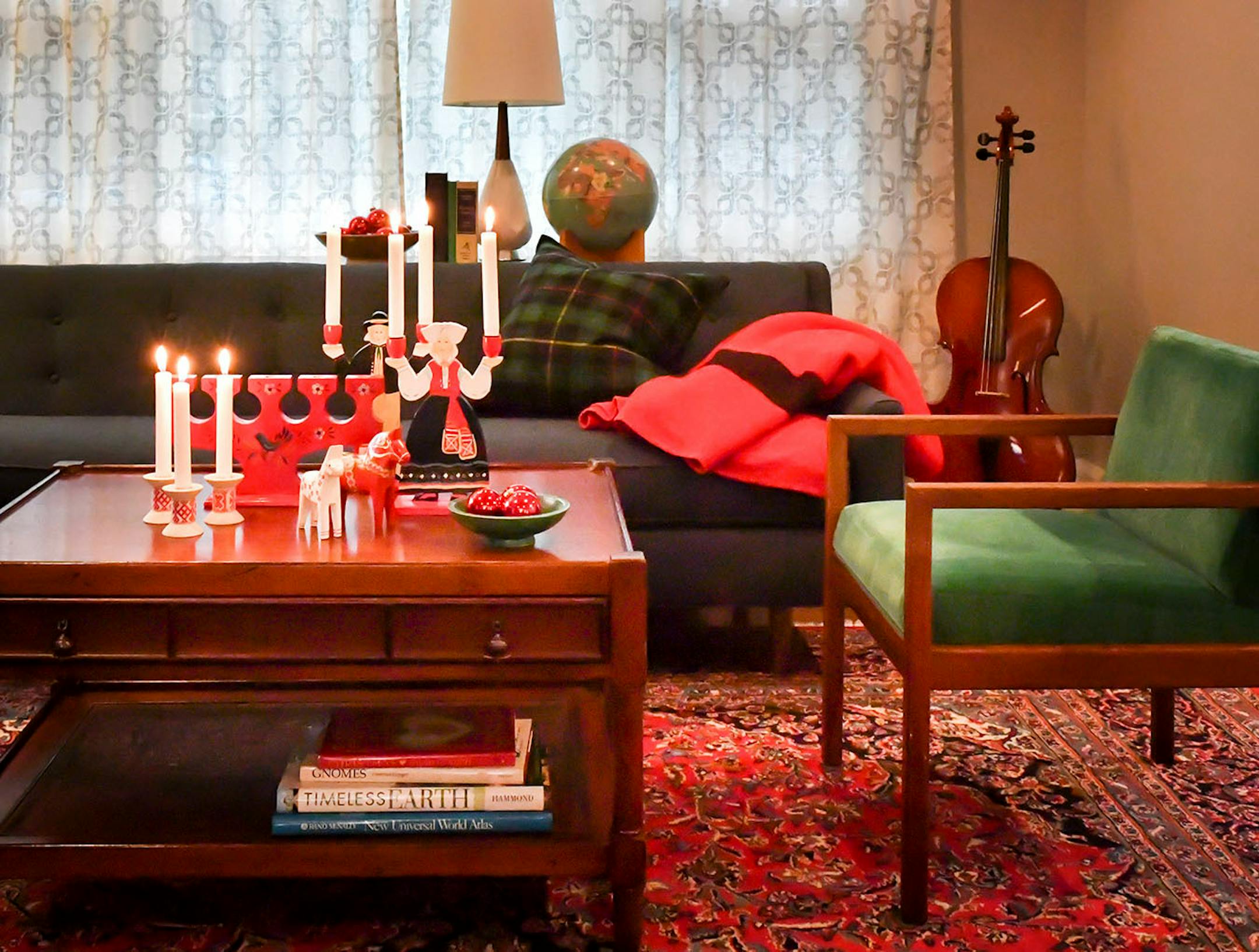 Homeowner Laura Walker's collections also complement the simple clean lines of her midcentury modern-style furnishings. Use other decor, such as the sofa's vintage Hudson Bay wool blanket, to repeat the red in the glass balls and Scandinavian folk art.