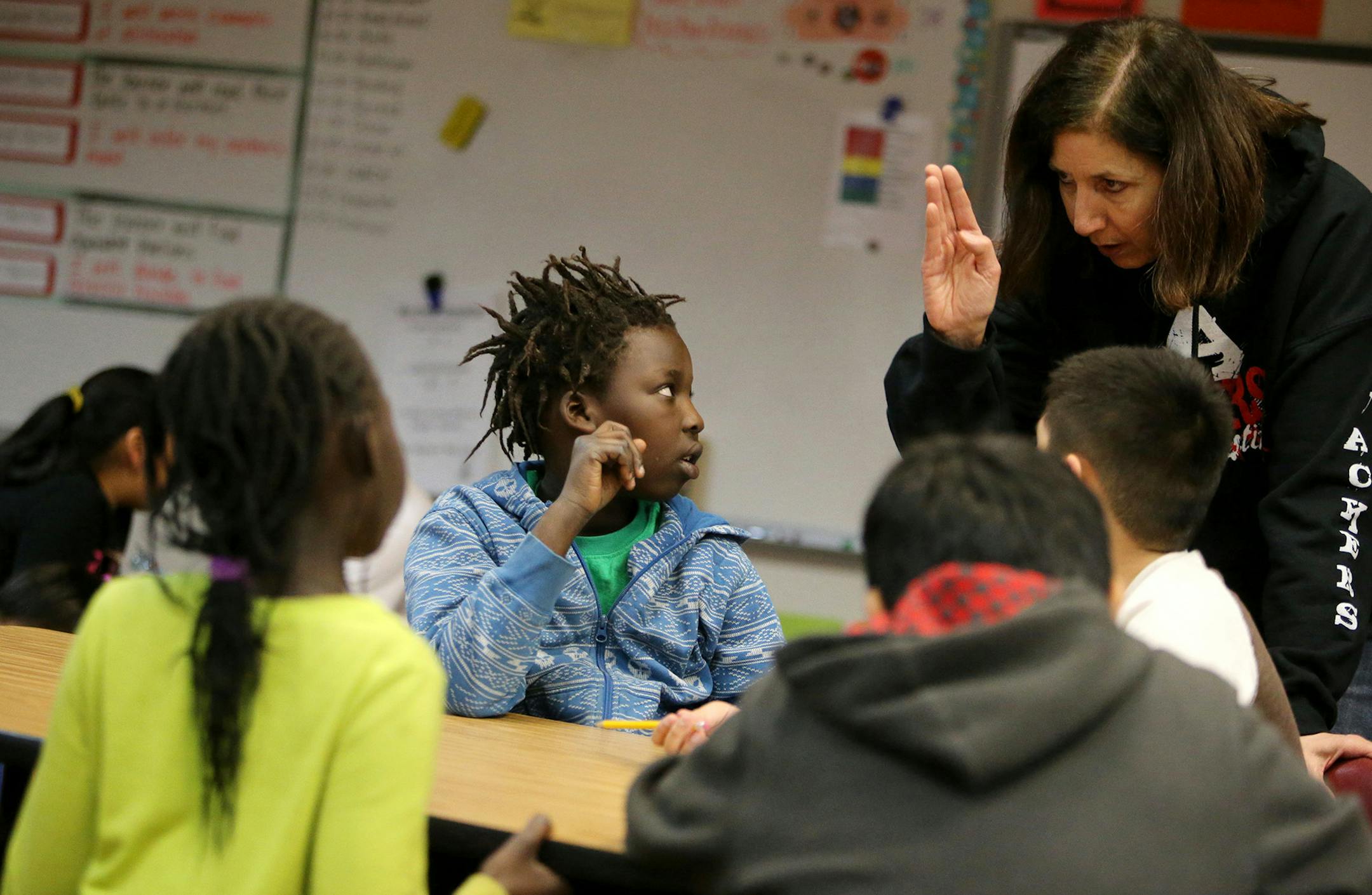 During intersession, Sumner Elementary School third grader Odear Lual consults with learning suite teacher Teresa Jette during a classroom exercise on things that live in the sea Wednesday, March 18, 2015, in Austin, MN. The learning suite is a larger classroom with more students but also with two teachers to meet the diverse needs of the students.](DAVID JOLES/STARTRIBINE)djoles@startribune.com The Hormel meat packing plant has transformed Austin Public Schools, bringing in a surge of Sudanese,