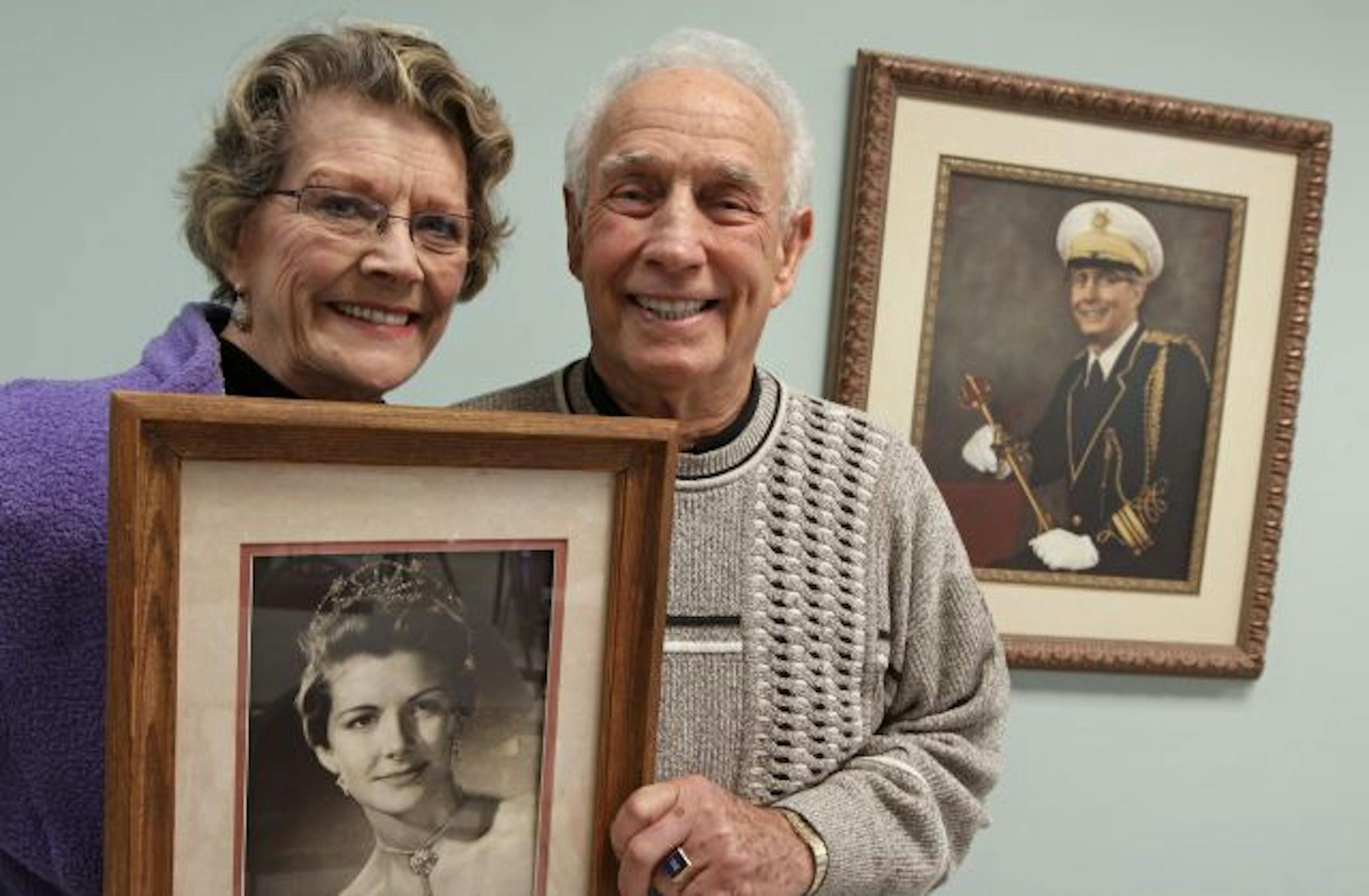 (left to right) Dorothy Furlong and Charlie Hall were photographed with photos when they were Winter Carnival queen and king. Hall and Furlong were former members of the Winter Carnival royalty who fell in love and decided to share their wedding and have it at the Winter Carnival in Rice Park on Saturday.